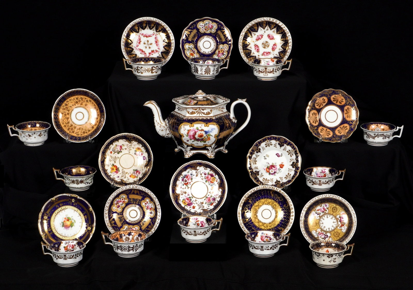 Crown Derby Porcelain Tea Set: An assembled collection of Crown Derby porcelain teacups and tea pot, each piece on numbered with pattern numbers, no hallmarks or stampings. To include floral motif teapot with lid, 6.75" h. x 11" x