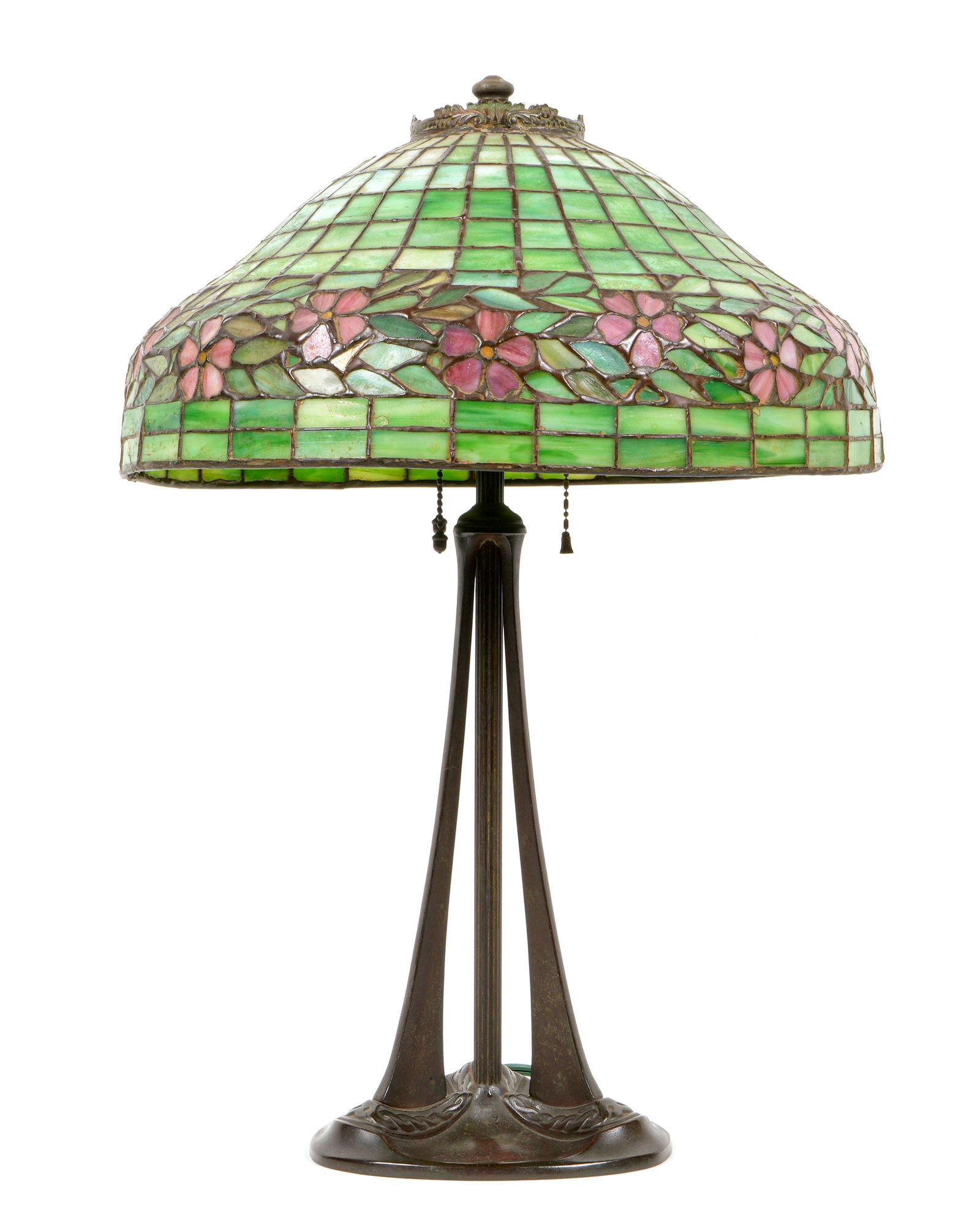 Handel Floral Leaded Stained Glass Lamp: Green stained and leaded glass shade with floral motif border, no visible markings, measures 8" x 16.25" dia. Triple socket patinated metal base marked Handel, sockets appear to be original with one r
