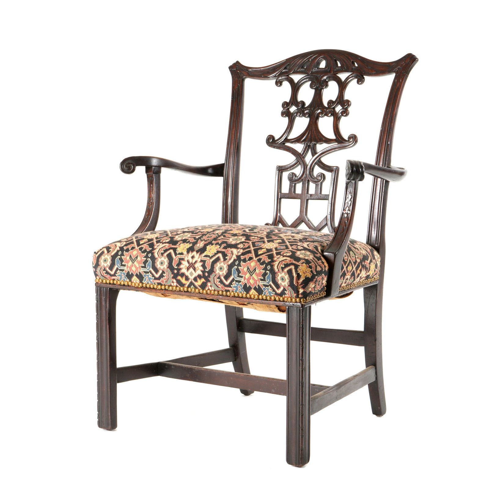 Chinese Chippendale Armchair: Carved and shaped top rail over reticulated back splat, shaped arms and supports. Straight front legs and stretcher, vibrant Turkish pattern upholstery. Overall 38.5" h. x 28.25" x 23". Condition: Wea