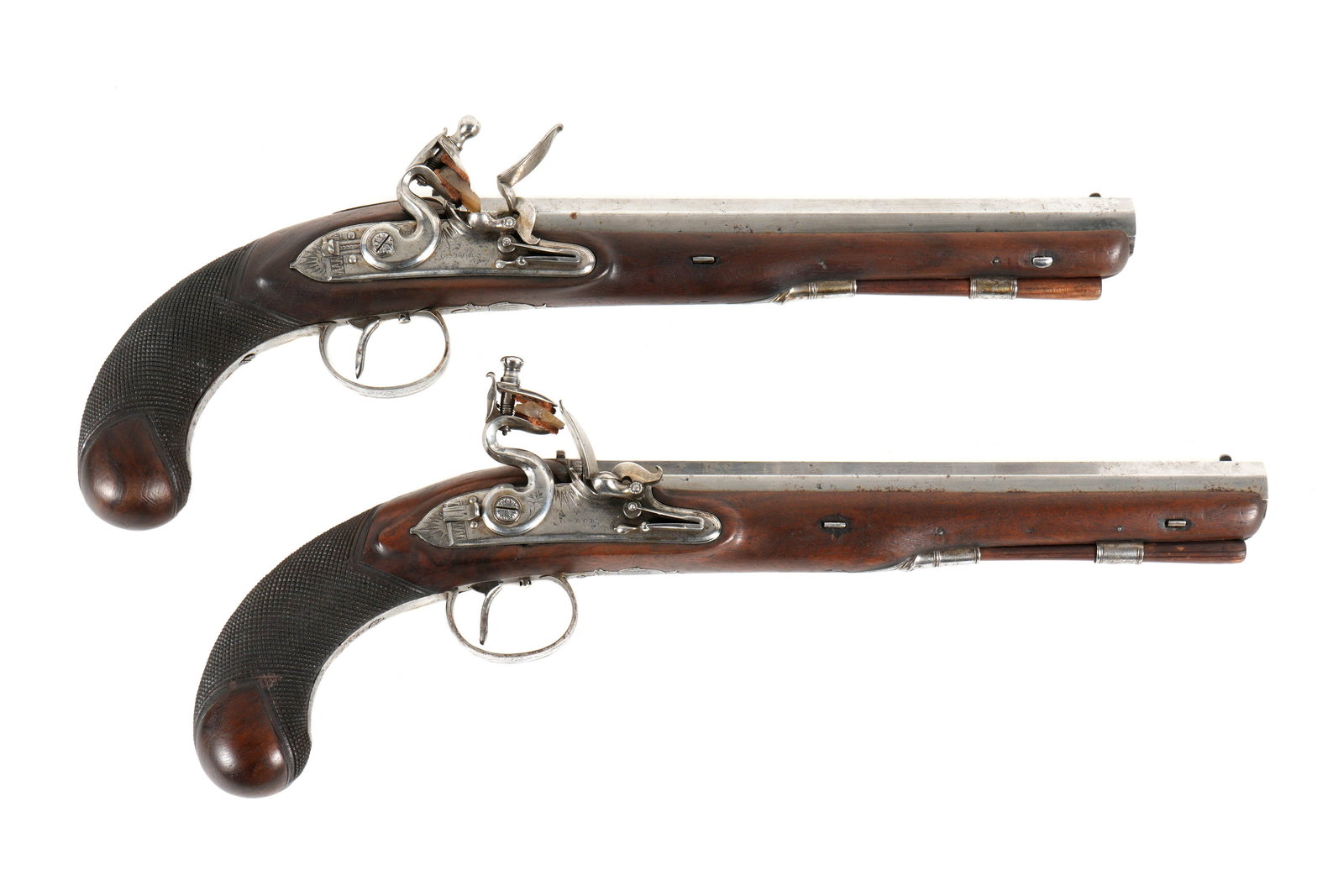 Pair Osborn 28 Bore Flintlock Dueling Pistols: Circa 1800, matched pair of dueling pistols marked Osborn on lockplate, 28 bore 10" octagonal barrel marked Pall Mall London. Walnut full stocks with checkered grips, ornate engraved trigger guard. Ov