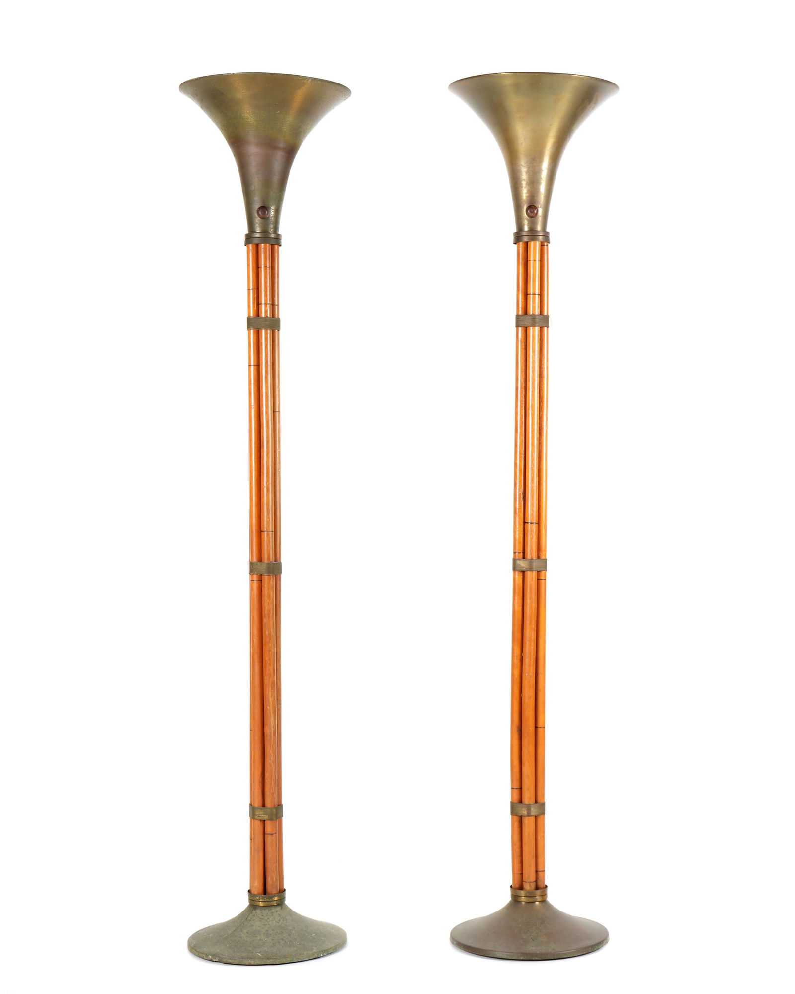 Pair Russel Wright Bamboo Form Torchiers: Designed by Russel Wright for Raymore, flared brass shades over faux bamboo supports bound with brass wire over flared brass bases. Overall 65" h. x 13.25" top dia. Condition: Dings to top shade rims,