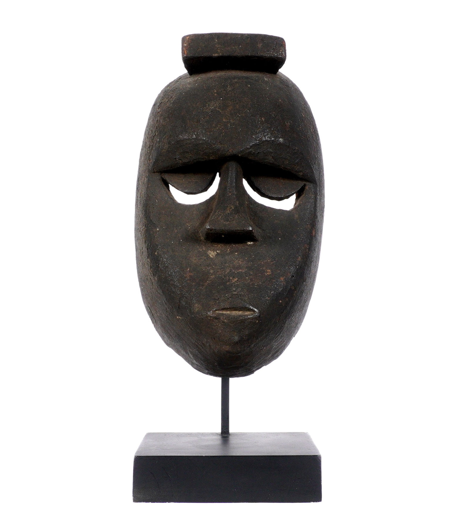 African Carved Dan? Culture Mask Ex-Sotheby's: Carved wood mask, possibly Dan Culture, older Sotheby's Belgravia tag inside, overall 9" h. x 5.5" x 3.5". Sold with metal and wood stand, 9.5" h. x 5" x 4". Condition: Chips and wear to back.