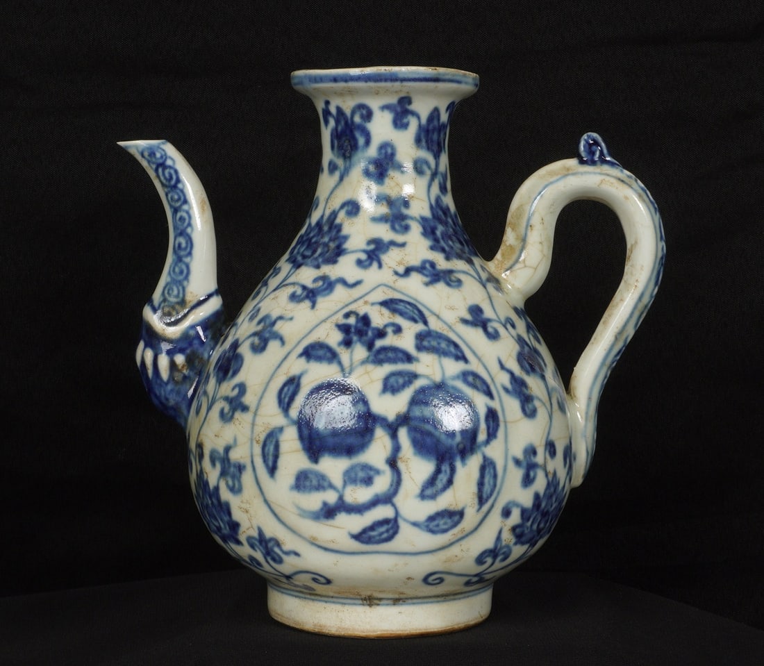 Chinese Blue and White Decorated Ewer: White crackle glaze ground porcelain ewer with blue floral decoration all over, unglazed foot and base. Overall 8.75" h. x 9". Condition: Chips to spout.