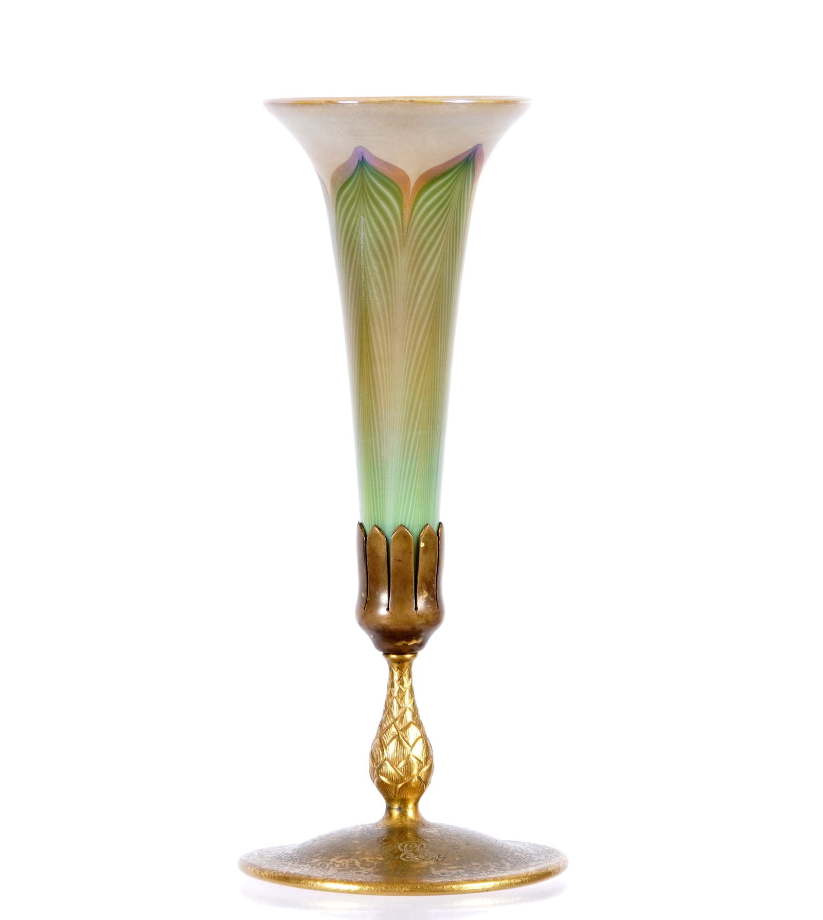 Tiffany Favrile and Gilt Bronze Trumpet Vase 1043: Textured gilt bronze base vase holder, monogrammed, well marked "Tiffany Studios, New York, 1043", overall 5.25" h. x 5" base dia. Sold with the accompanying pulled feather Favrile glass trumpet vase,