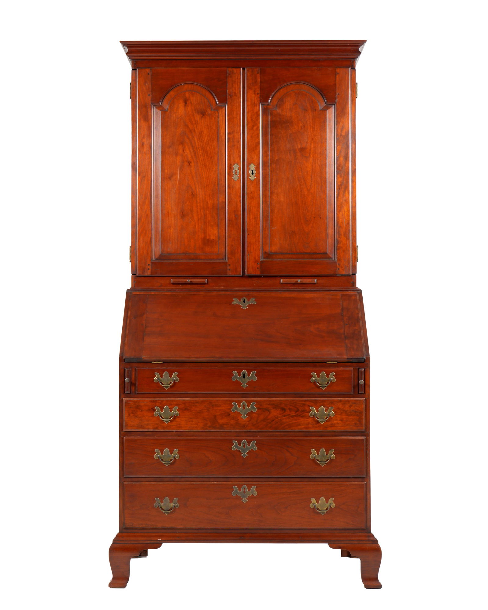 Eldred Wheeler Cherry Secretary Bookcase: Top with molded cornice over two carved blind doors, fitted interior with five shelves, top shelf with drawers and pigeon holes. Slant front base, fitted interior with prospect door, pigeon holes, and