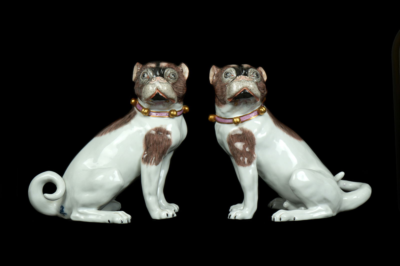Pair Carl Thieme Dresden Porcelain Pug Dogs: Pair polychrome decorated porcelain pug dogs, each with Carl Thieme Dresden markings, one impressed E1456T under tail. 7" h. x 4.5" x 7.5". No damage or repairs noted under black light.