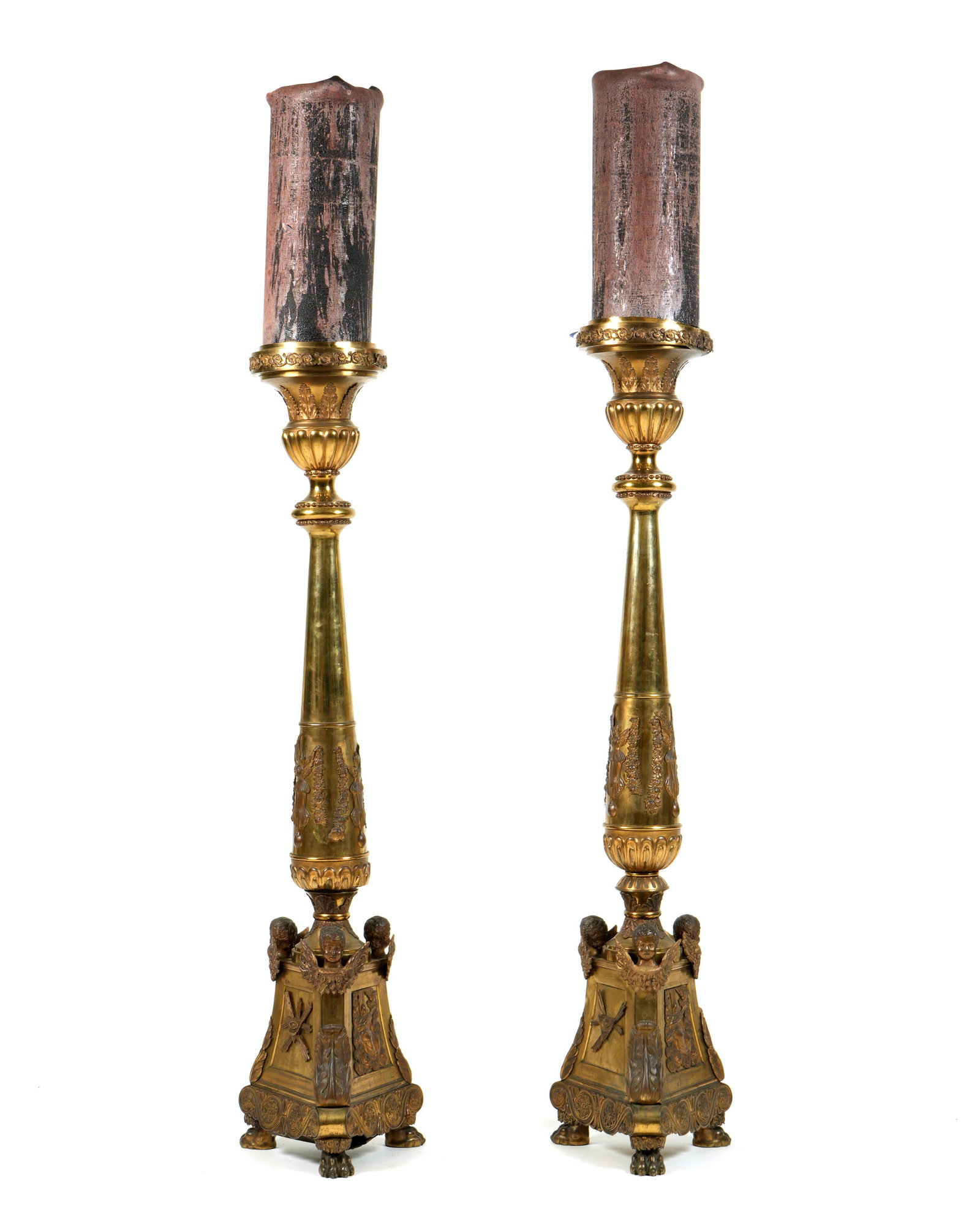 Pr 19th C French Empire Bronze & Brass Torchieres: Circa 1833, center iron pricket over shaped brass column, applied foliate scroll, acanthus leaf and winged caryatids. Triangular gilt bronze base with decorated panels and figural cherub busts. Inscri