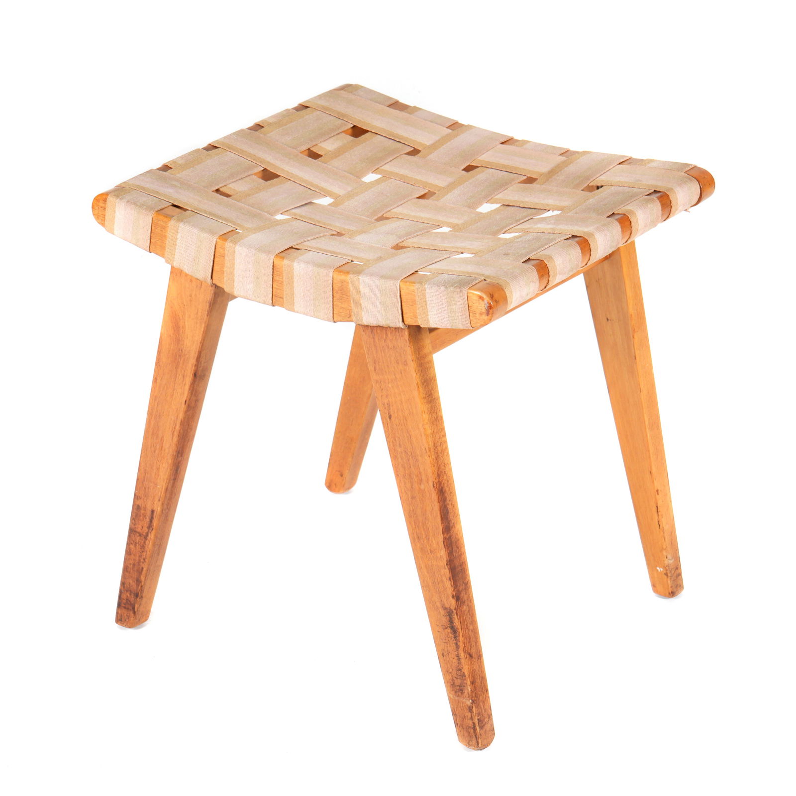 Jens Risom for Knoll Model 667-L Stool: Designed by Jens Risom for Knoll, wood framed, woven canvas seat, label inside stretcher. Overall 17.25" h. x 16.75" x 15". Condition: Fading to canvas, scratches to wood.