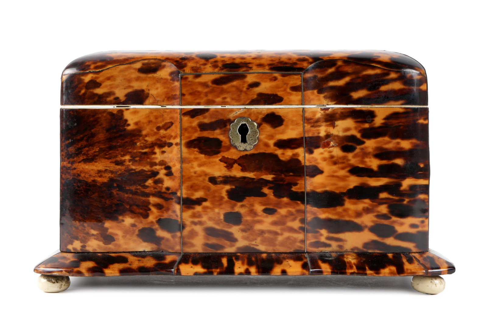 English Regency Tortoiseshell Tea Caddy: Tortoiseshell clad serpentine case, hinged lid, fitted two section interior with lids, all on bun feet. Overall 4.5" h. x 8" x 5". Minor chips to lower corners.