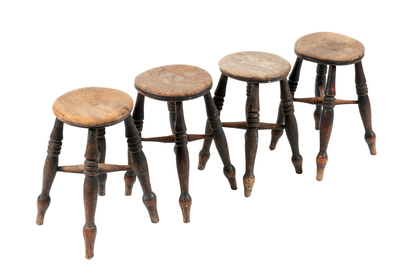 Four 19th Century English Mixed Wood Stools: 19th Century, each with round figured wood tops, turned legs and stretchers, overall 19.75" h. x 18.25" base dia. Tops 11.5" dia. Condition: Chips to feet, other wear consistent with age everyday and