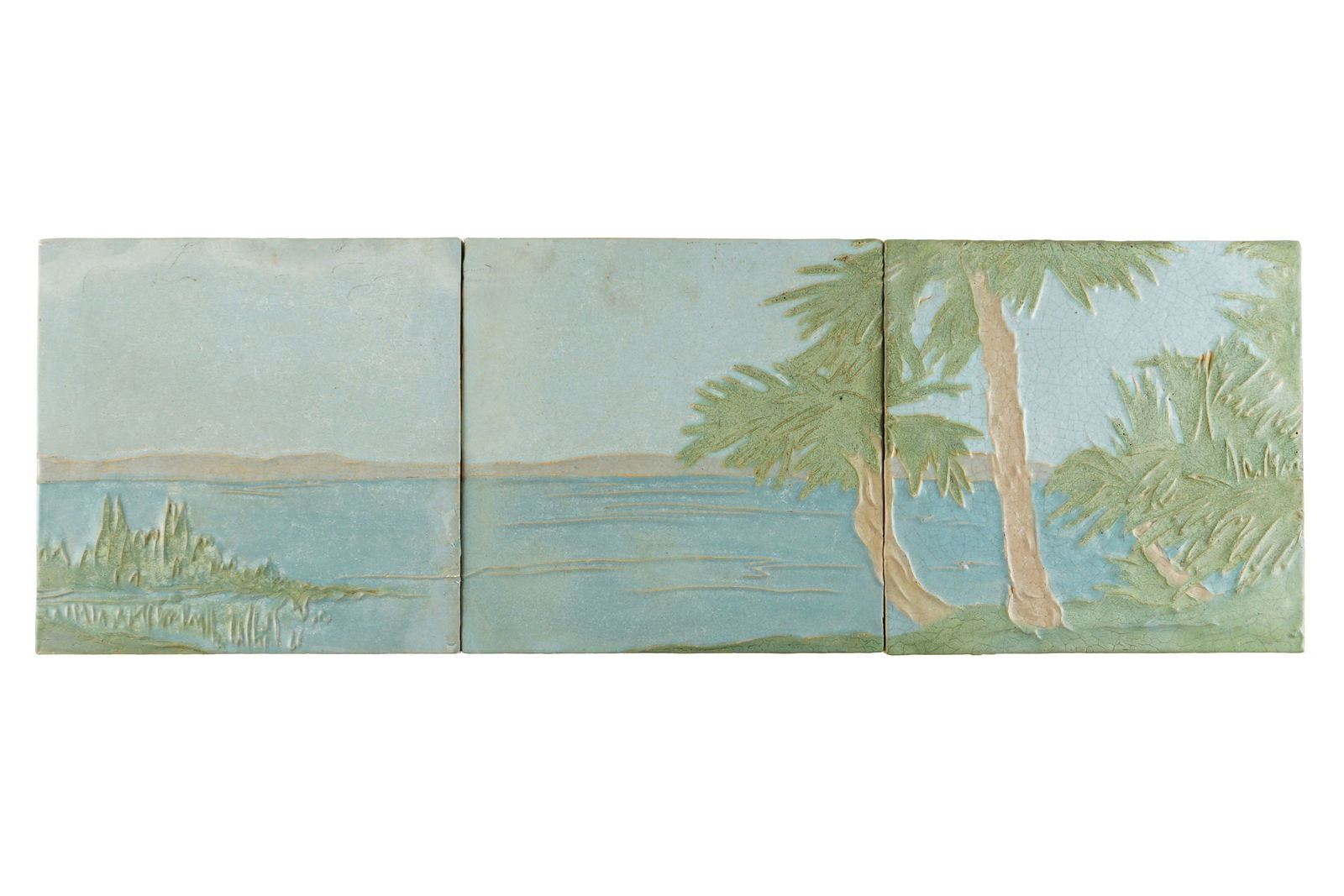 Three Large Rookwood Architectural Faience Tiles: Three pieces total in pattern 3028, palm trees by the waters edge. Each well marked on back, each tile measures 12" x 12". Condition: Crazing, very minor chips.