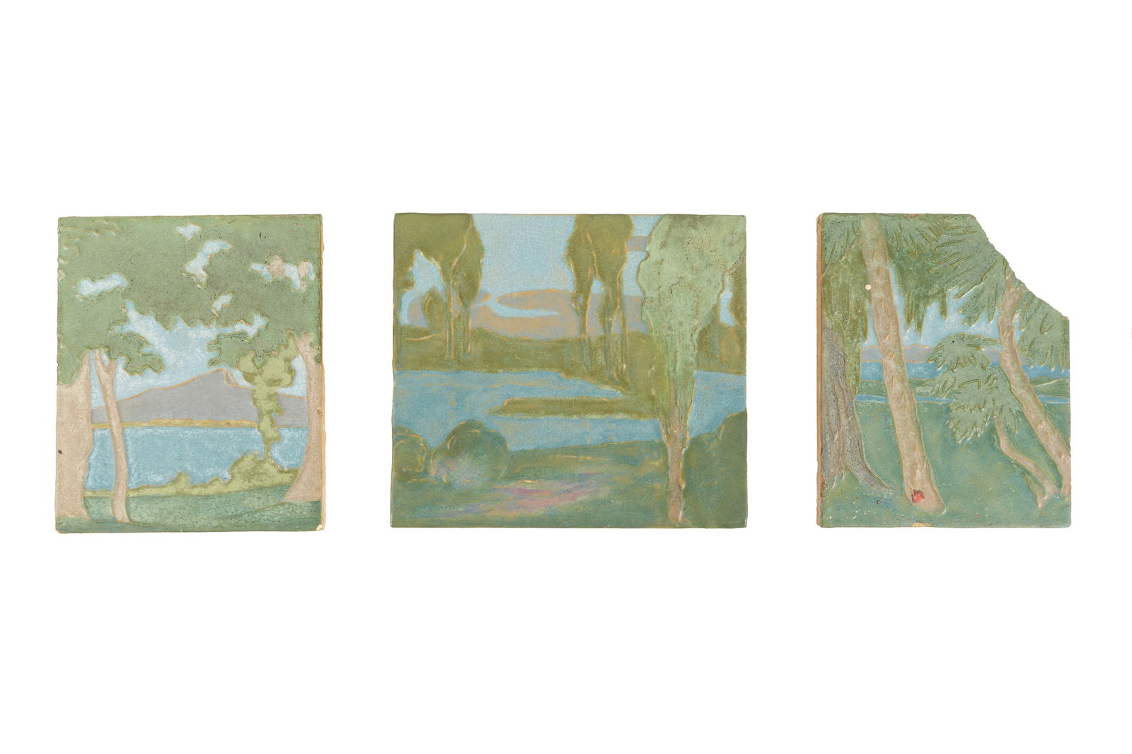 Three Large Rookwood Architectural Faience Tiles: An assembled collection of three pieces, all well marked on back, to include 1) Pattern 1276, trees by pond, 12 x 10". 2) Pattern 1651, trees by waters edge, 12" x 13.5". 3) Pattern 3027, palm trees b