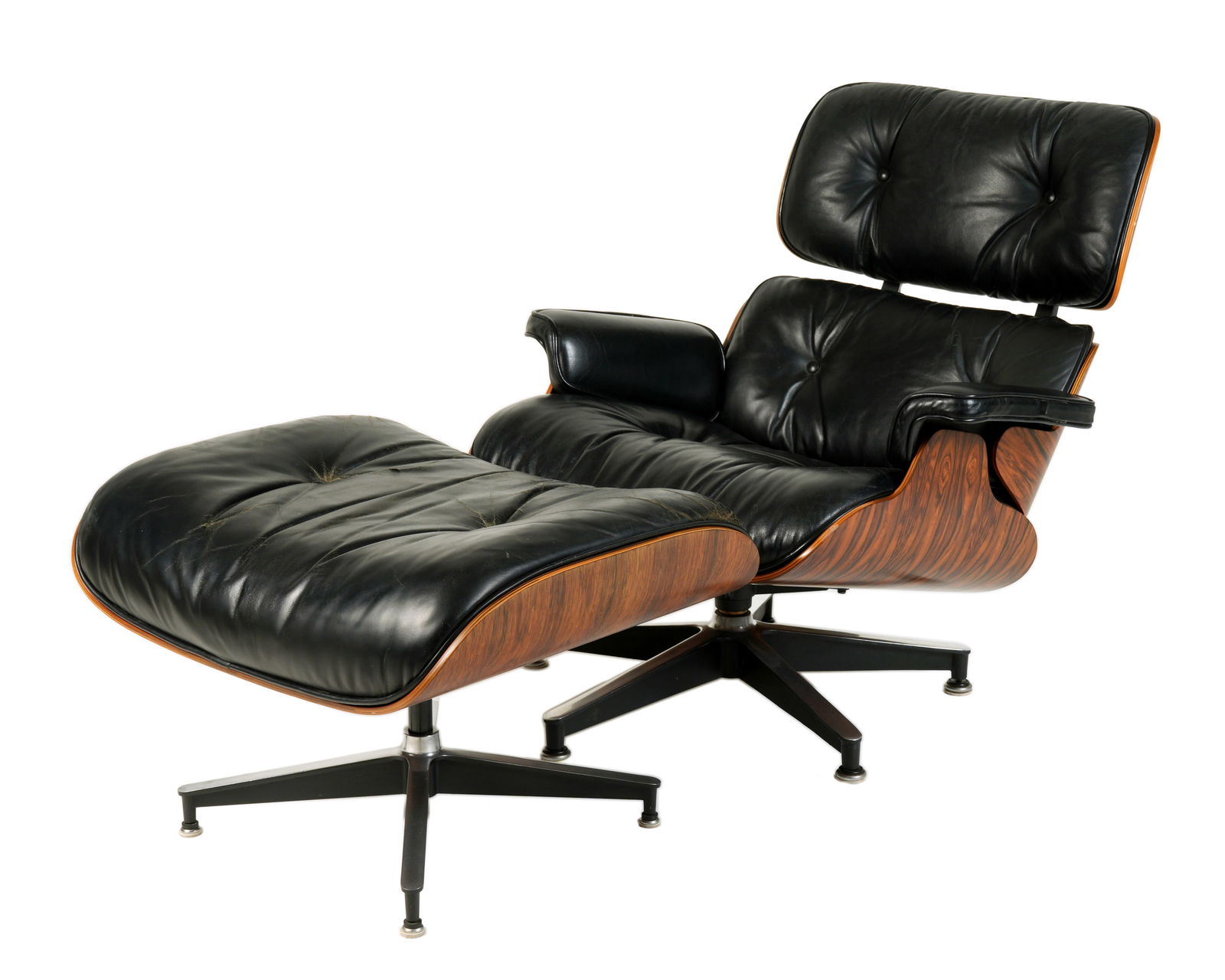 1970's Eames Lounge Chair & Ottoman Herman Miller: 1970's Herman Miller lounge chair & ottoman model 670, designed by Charles & Ray Eames. Molded rosewood frames, aluminum supports and base. Black leather upholstery. Tagged underneath. Chair approx. 3