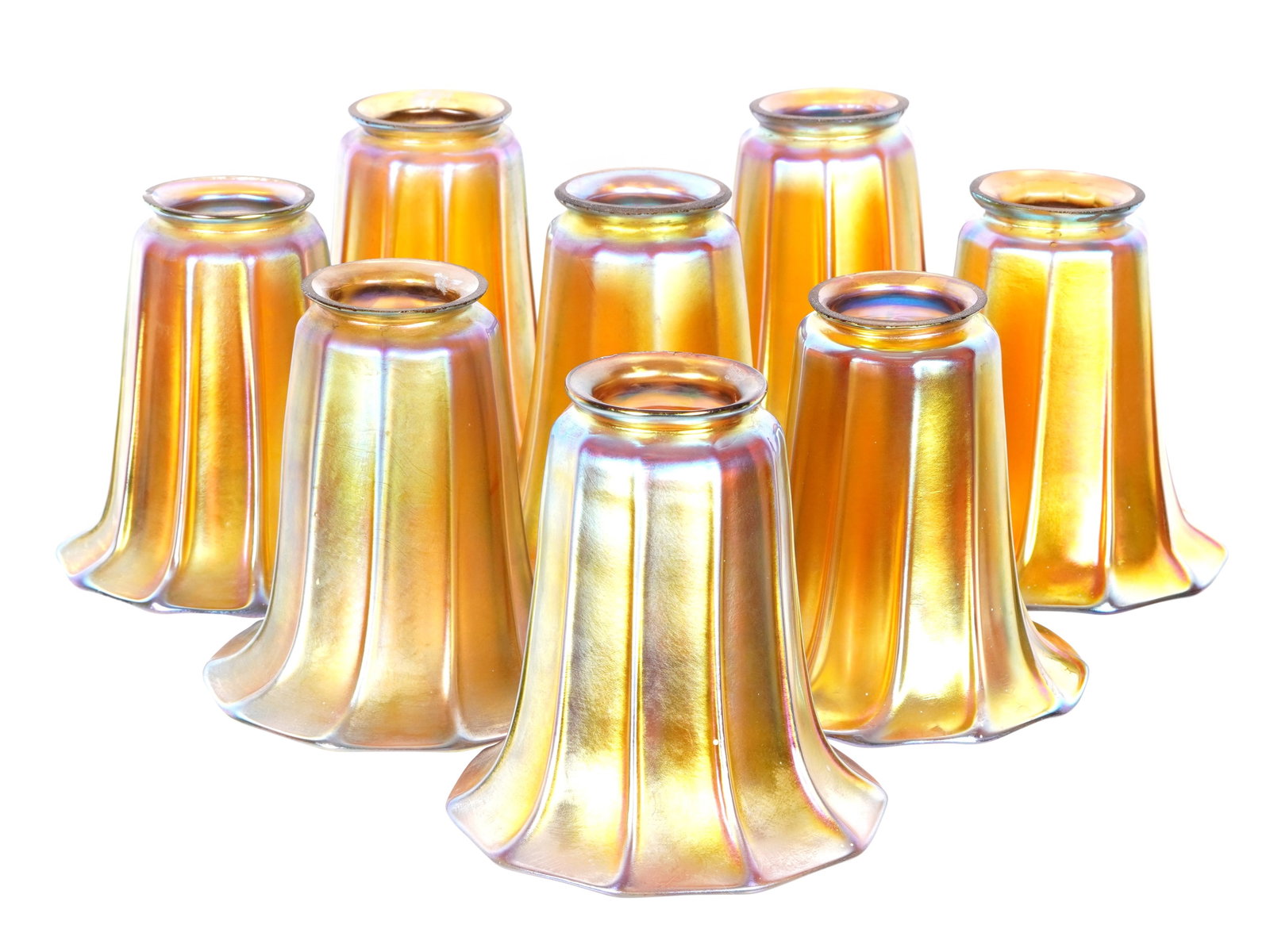 Set of Eight Steuben Signed Gold Aurene Shades: Set of eight iridescent gold Aurene lamp shades, ribbed tulip form, stamped Steuben on fitter rims, most stamps blurred and rubbed. Overall 5" h. x 4.75" bell dia. Fitter rim 2 1/4". Condition: The oc