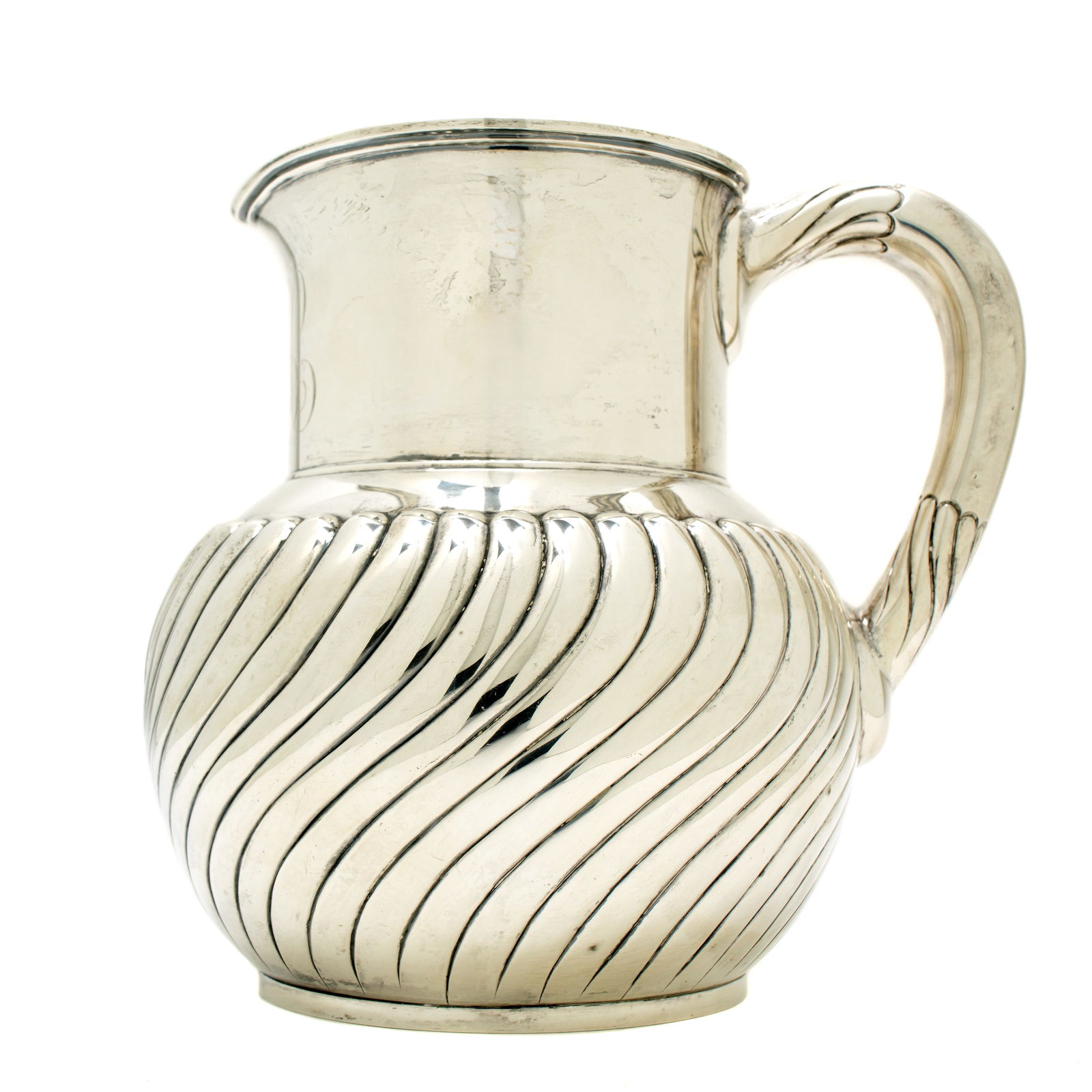 Tiffany & Co. Sterling Silver Pitcher: 4 1/2 pint sterling silver pitcher by Tiffany & Co., ribbed body with slight twist, well marked on base. Monogrammed on neck. 7" h. x 7.5". Approx. 22 troy oz.