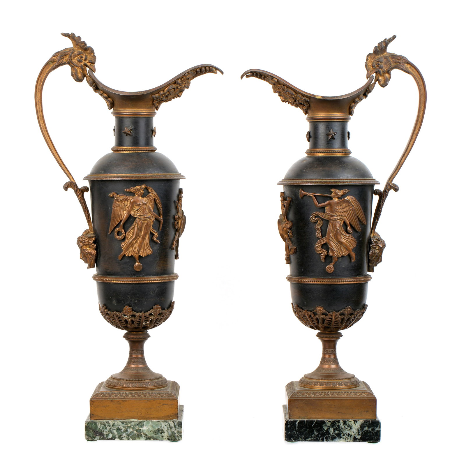 Pair French Empire Style Bronze Ewers: Early 20th Century bronze and metal ewers, figural chicken head and female mask handle. Body with affixed angels and musical instruments. Square foot over marble base. Overall 15" h. x 7". Condition: