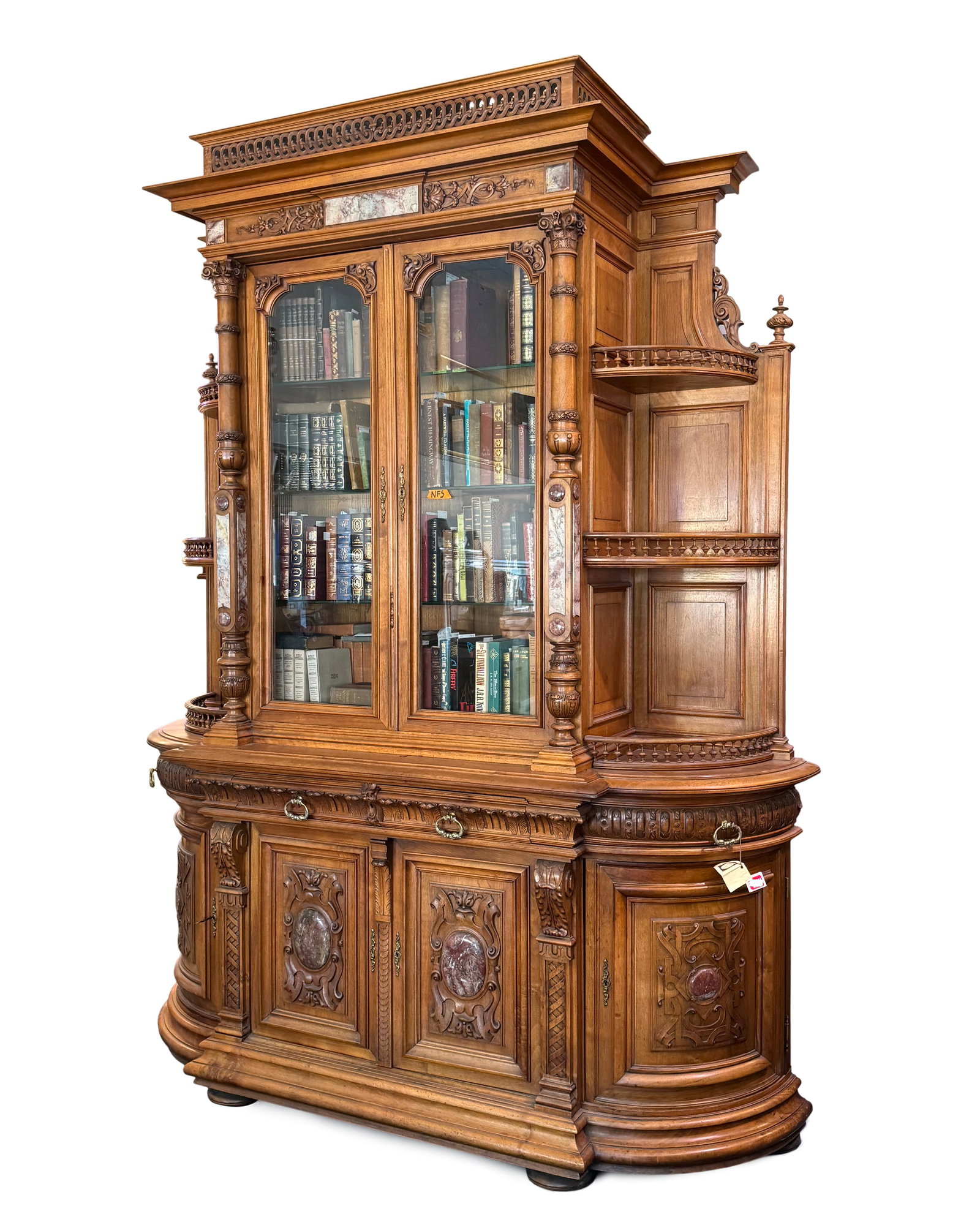 Monumental 1880's Philadelphia Oak Bookcase: Monumental and impressive bookcase with pierced gallery top, carved crest and column stiles with applied marble panels. Center 2 glass doors with internal shelves, flanked on either side with rounded