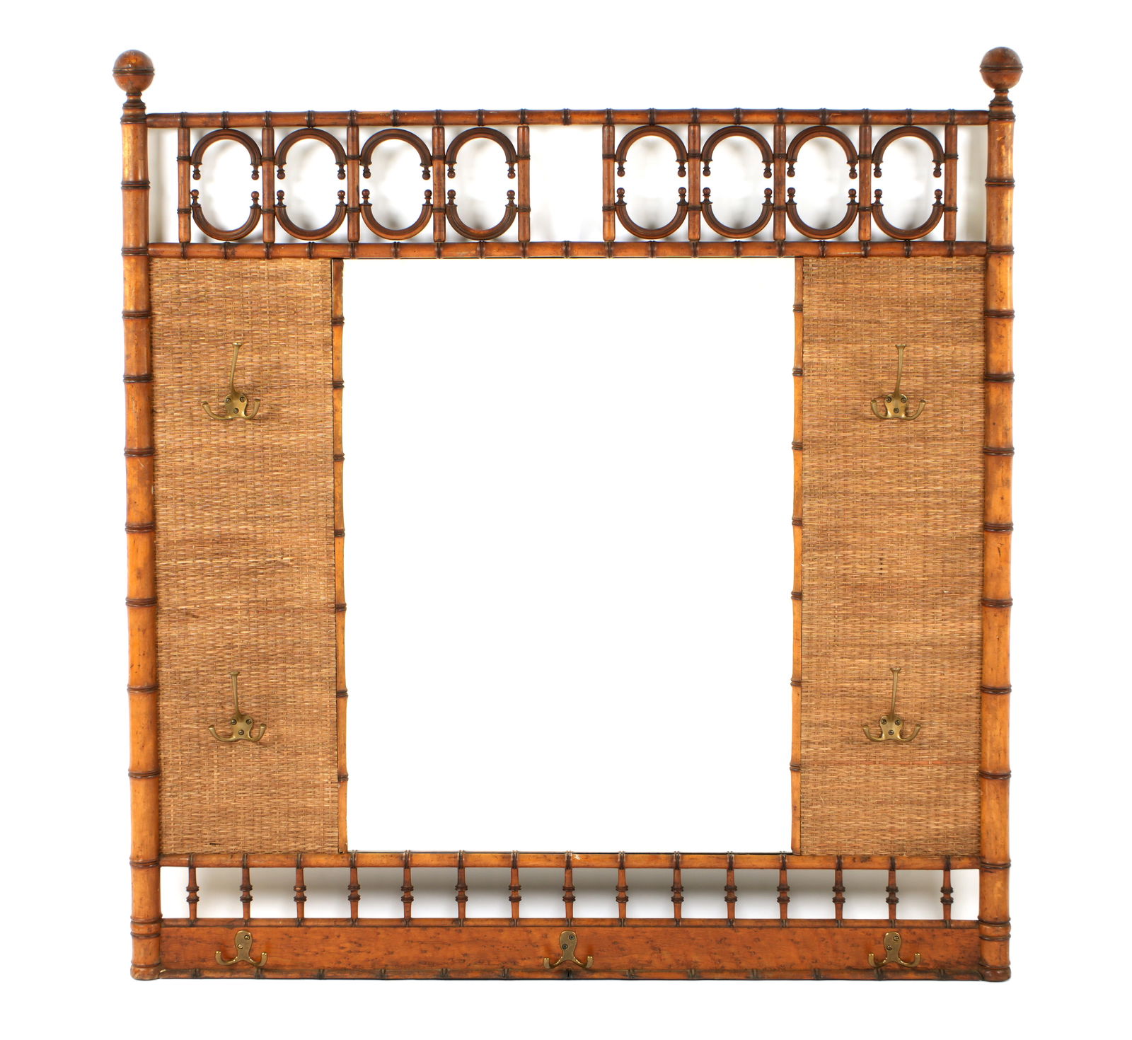 Carved Faux Bamboo Coat Rack Mirror: Carved wood faux bamboo frame, center mirror, woven rattan panel either side, seven multi arm coat hooks. Overall 49" h. x 46.5". Condition: Wear to frame, center hoop missing. From Duck & dolphin ant