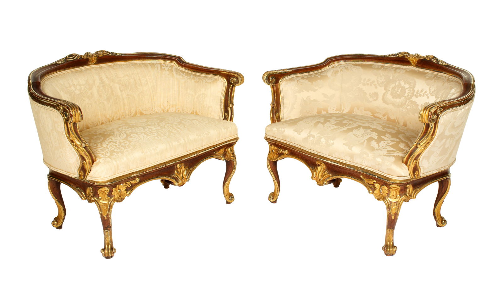 Pair 19th C. French Carved Parcel Gilt Wood Settees Ex-Christie's: Pair Louis XV style canape settees, carved oak frames, gilt and paint decorated accents, shaped arms. Shaped skirt and legs ending in scroll feet. Floral pattern silk upholstery. Overall 33.25" h. x 4