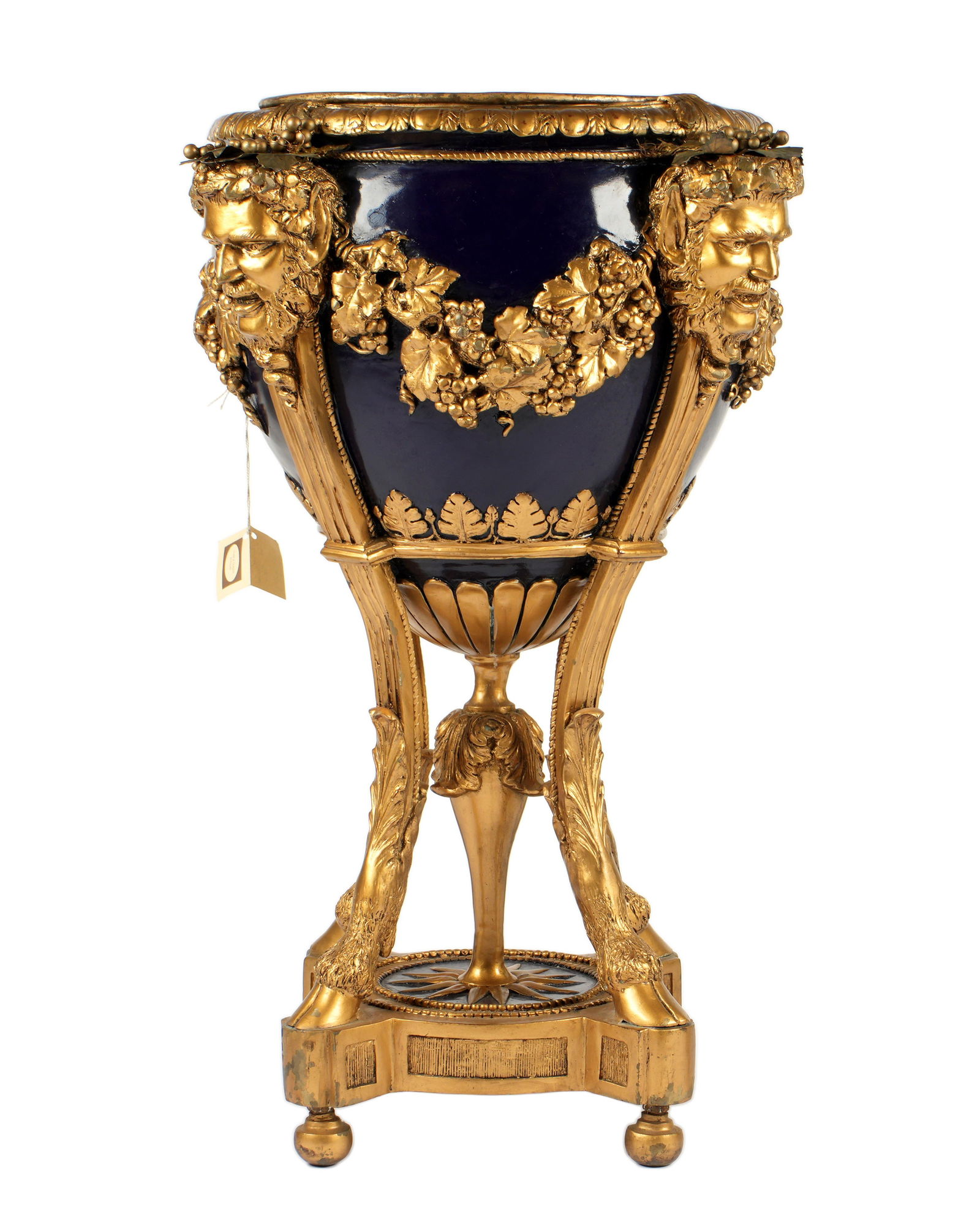 Large Bacchanalian Bronze Planter: 20th Century, heavy bronze planter with removable insert, gold and cobalt blue paint, decorated with figural Bacchanalian masks and grape vines. Four supports ending in hoof feet, round lower stretche