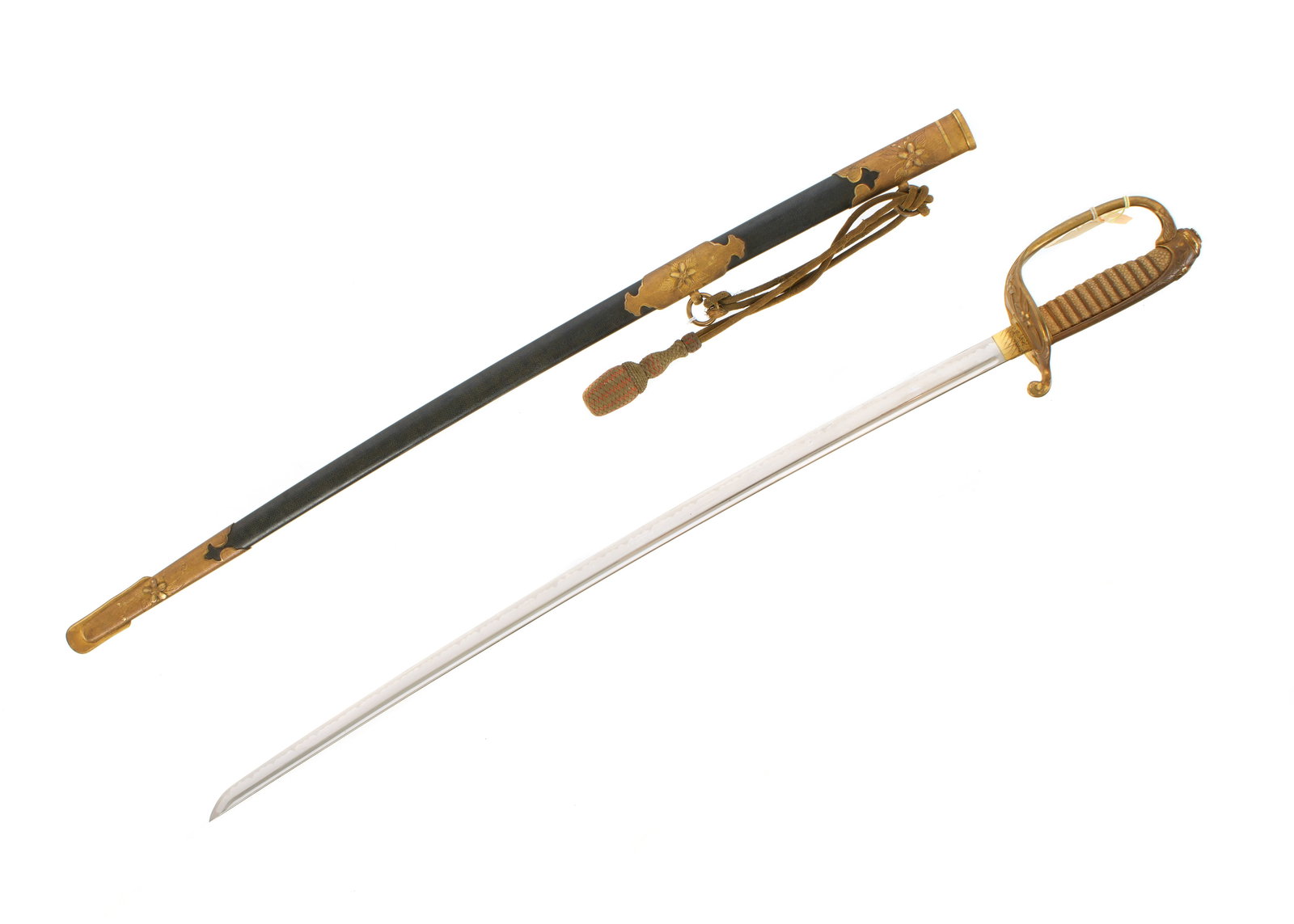 Japanese WWII Kyu-Gunto Naval Sword: Brass hilt with shagreen sharkskin grip, folding counter guard, 24.5" blade with single fuller. Shagreen style wrapped scabbard with brass mounts, officers tassel or sword knot. Overall 33.25" long.