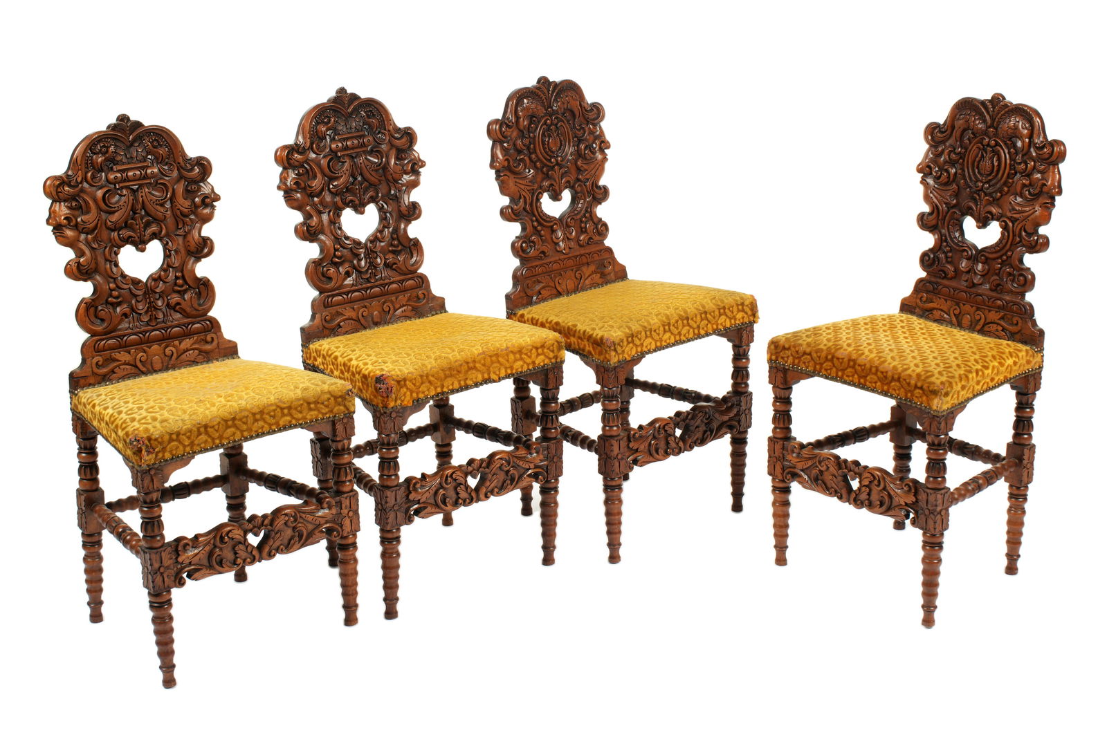 Four French Renaissance Style Walnut Side Chairs: Late 19th Century, ornately carved walnut frames, turned legs, tacked patterned upholstery seats. Overall 37.5" h .x 17.75" x 15.25". Condition: Wear and tears to upholstery. From Duck & Dolphin Antiq