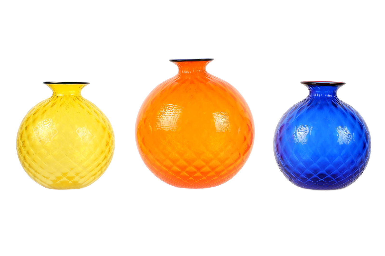 Three Venini Murano Monofiori Balloton Vases: Three pieces total, quilted Balloton glass vases made by Venini, each signed and dated. Orange vase measures 7.25" h. x 6.5" dia. The blue and yellow vases 6" h. x 5"