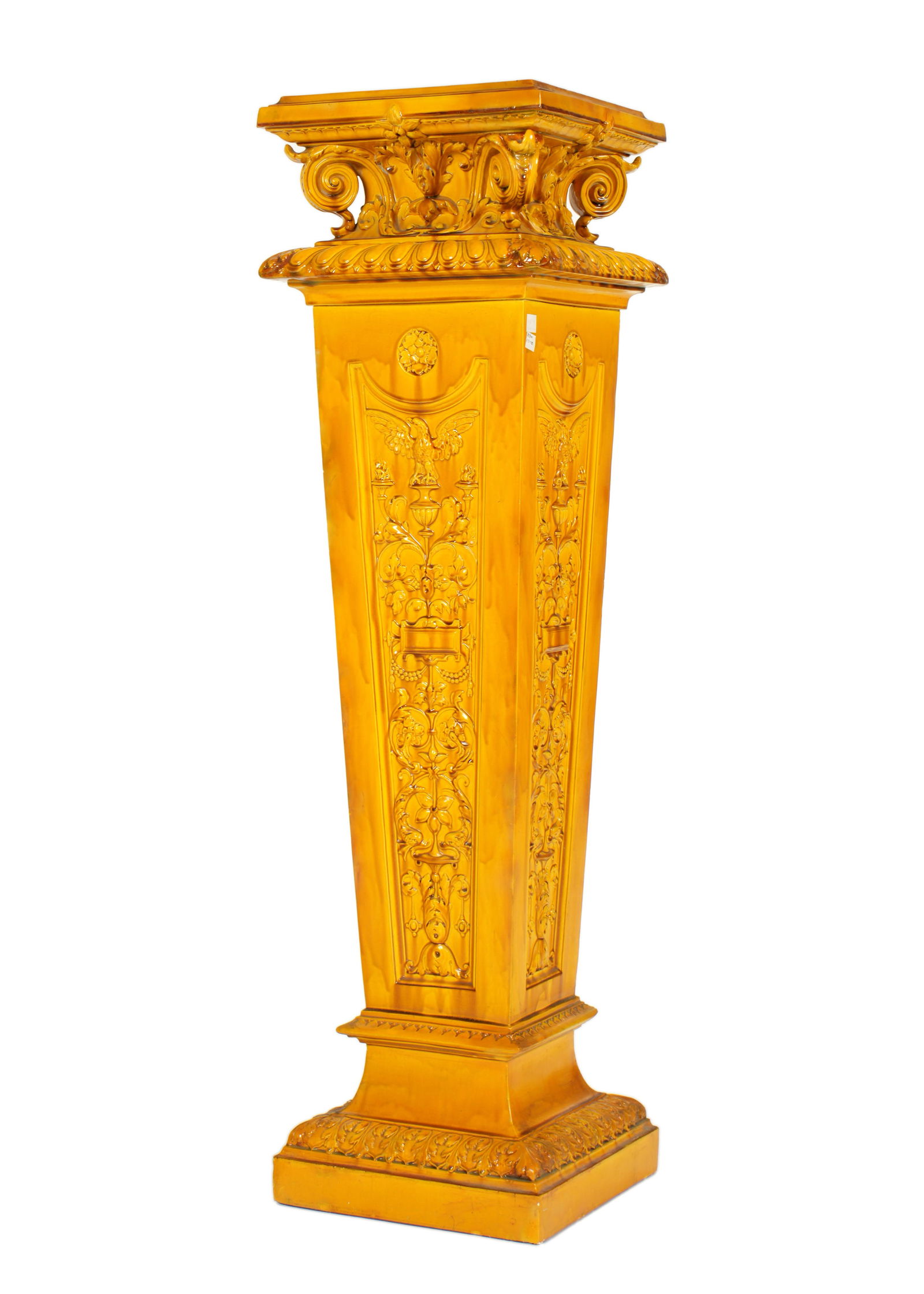 French Majolica Pedestal Stand: Mottled yellow majolica glaze, tapered body with raised eagle over urns and floral sprays, unmarked, overall 42.5" h. x 11.75" x 11.75". Condition: Crazing, minor touchups, chips. From Duck & dolphin