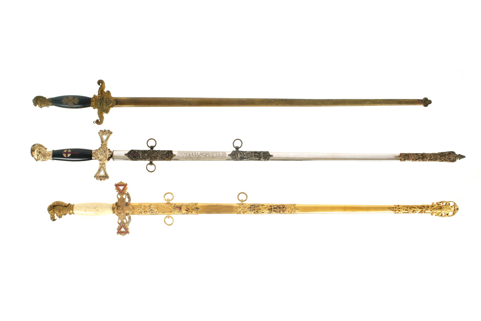Three Masonic Knights Templar Fraternal Swords: An assembled collection of three Knights Templar swords, assorted makers and ages, longest measures 39" long. Condition varies, please see photographs for condition.