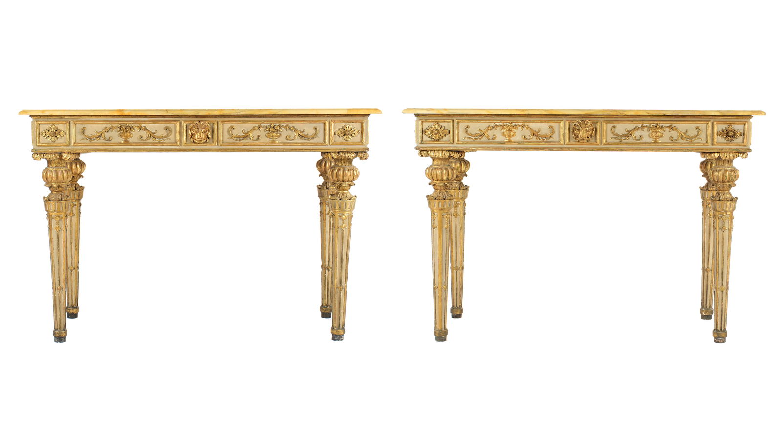 Pair 18th / 19th Century Italian Marble Top Console Tables: Rectangular variegated Siena marble tops over profusely carved, painted, and gilded wood bases. Skirt with lion masks, foliate scroll and floral medallions. Tapered and fluted legs with urn form tops.
