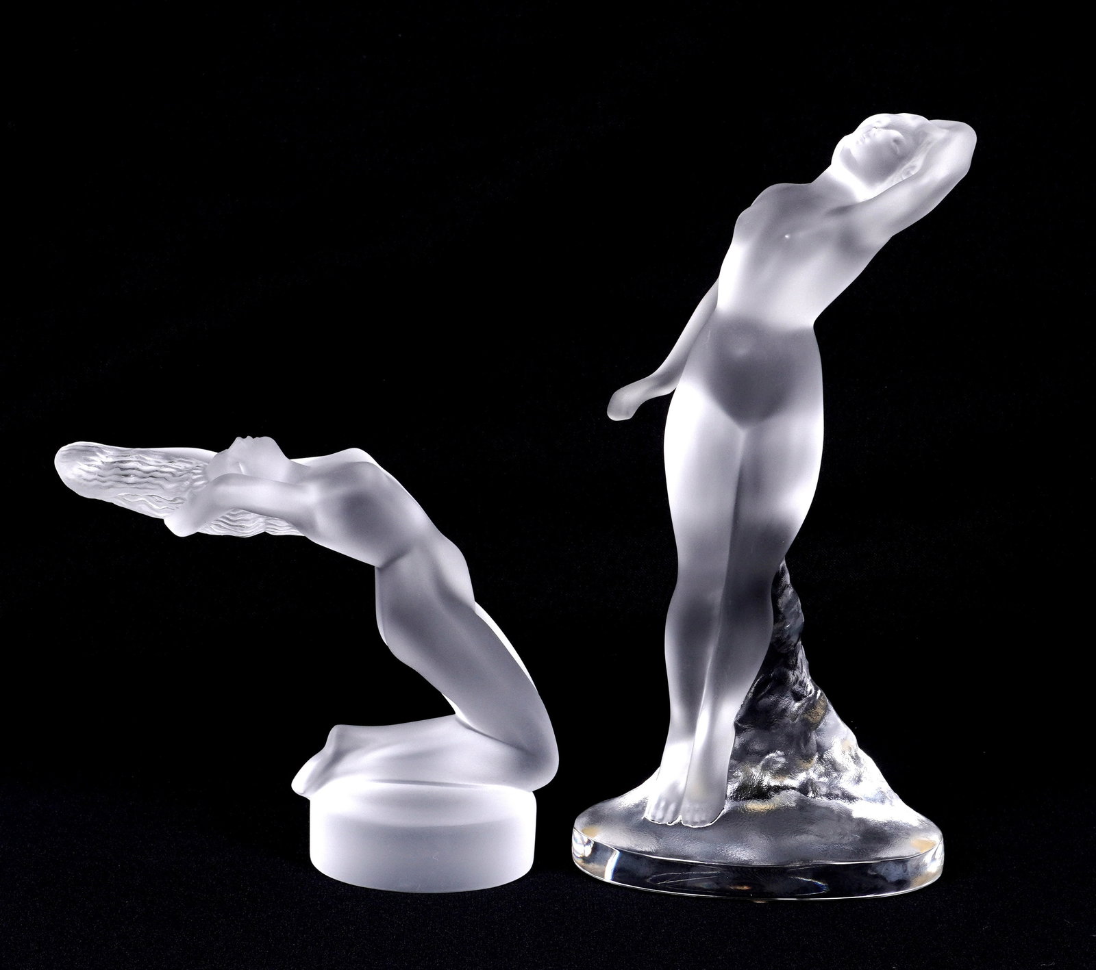 Two Lalique Crystal Figures Danseuse & Chrysis: Two frosted and molded crystal figures from Lalique to include 1) "Danseuse:, figure of standing nude woman, 9.5" h. x 4.5" x 3". Original box 5" x 12" x 7.5". 2) "Chrysis", nude woman arching backwar