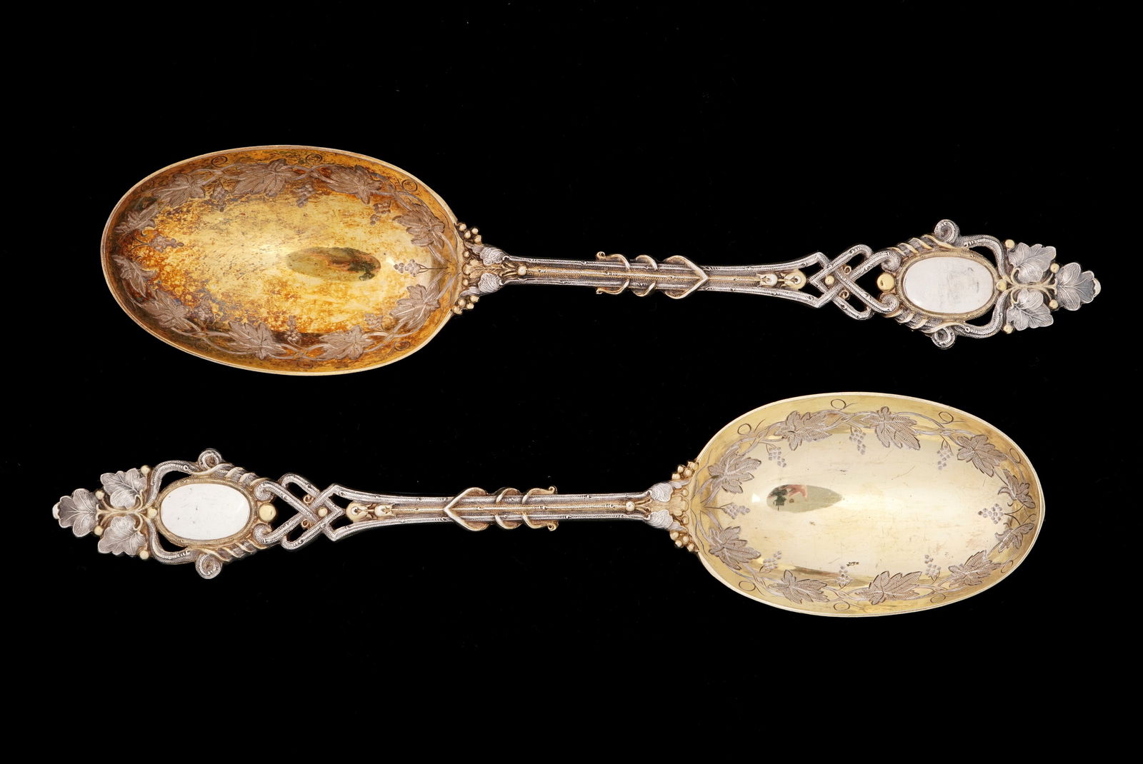 Pr Frederick Elkington English Silver Tablespoons: Pair English sterling silver tablespoons by Frederick Elkington; hallmarked 1874, Birmingham. Vermeil bowls with engraved grape vine motif, reticulated shank, grape vine finial. Well marked under bowl