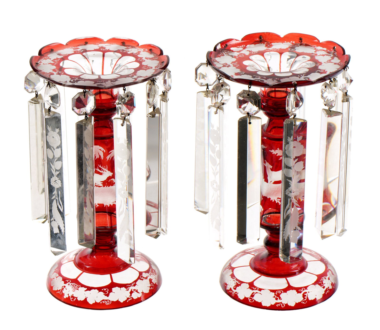 Pr Bohemian Ruby Cut to Clear Luster Candlesticks: Pair grape vine motif ruby cut to clear glass bodies, alternating etched and clear prism drops. Overall 10.25" h. x 6.25". Condition: Minor fleabites to several prisms. Many rough spots and fleabites