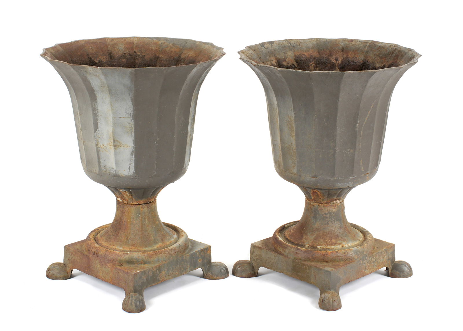 Pair Large Cast Iron Fluted Garden Urns: Flared and fluted neoclassical style planter bowls over square base, all on four paw feet. Unmarked. Overall 36" h. xx 37.75". Condition: Obvious signs of weathering, rust. Shippers note very heavy.
