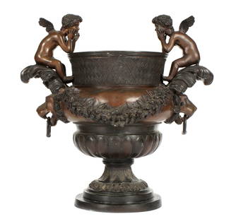 Bronze Figural Cherub Garden Urn / Planter: manner of DUVAL-CAMUS, Pierre, (French, 1790-1854): Patinated bronze garden urn featuring two winged angels over lion mask handles, floral garland accents. Overall 31" h. x 31" dia. Condition: One ang