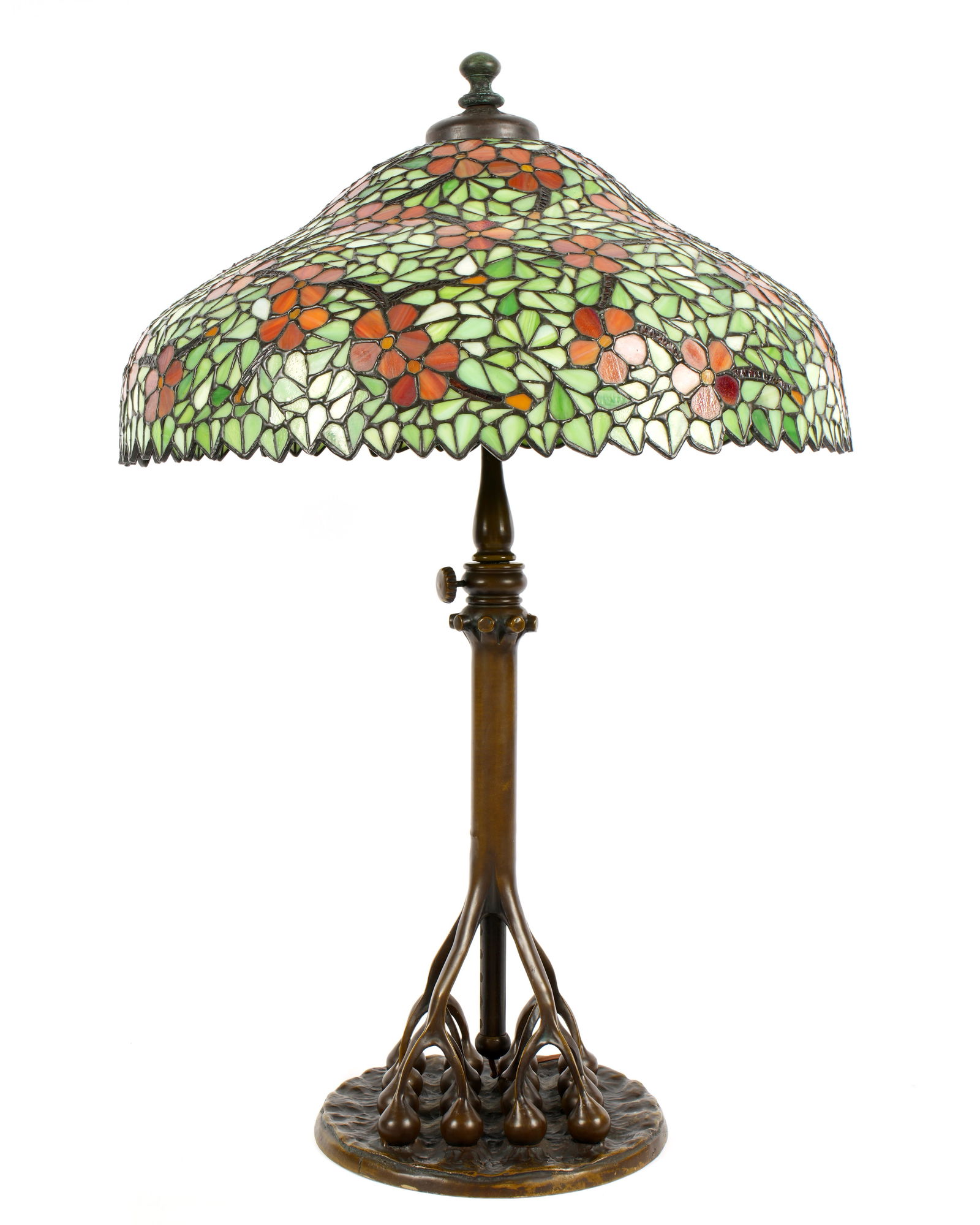 Dogwood Pattern Leaded Glass Table Lamp: Large bell form leaded stained glass shade in the Dogwood pattern, attributed to Handel with Handel metal tag inside, measures 9.5" h. x 23.5", aperture 4". Sold with a Tiffany Studios style adjustabl