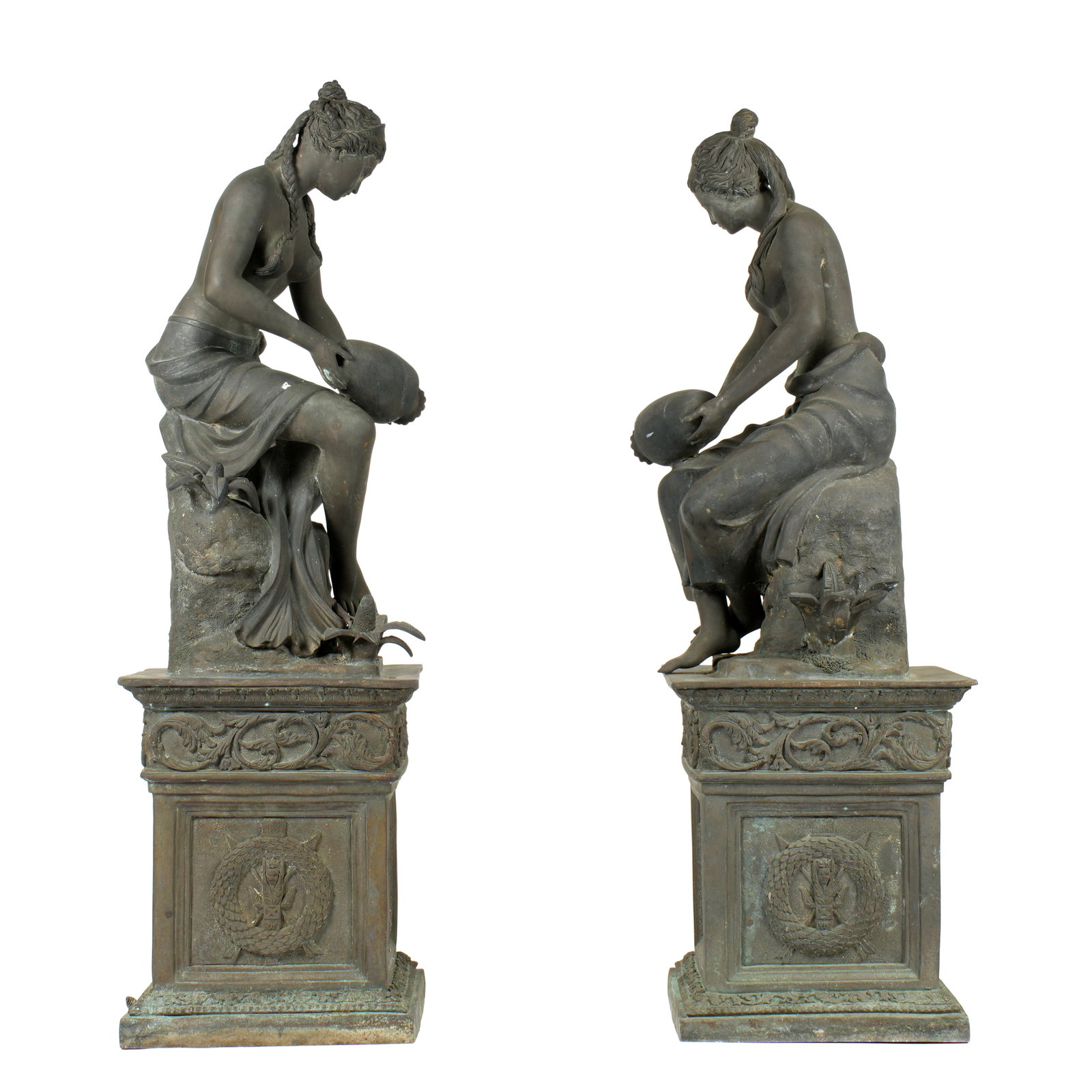 Two Bronze Women at the Well Garden Fountains: Pair of similar, but not identical, seated semi nude maidens each holding a vessel. Pedestal bases, no visible signatures. Copper tubing from base to vessels. Overall 61.5" h. 19" x 21". Condition: We