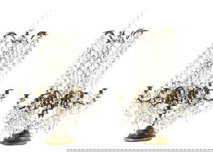 Pair French Bronze and Crystal Table Girandoles: Top tapered spire crystal finials over bronze 6 light base, foliate scroll arms. Crystal faceted crystal swags and drops, unmarked. Overall 31" h. x 21". Condition: Wear to gilt finish on bronze. The