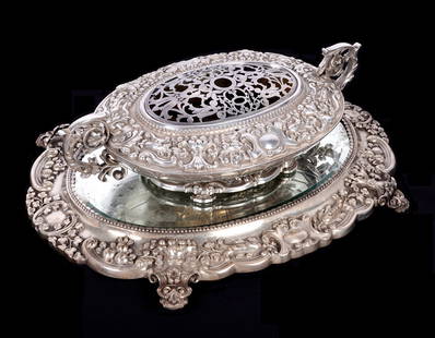 Portuguese Silver Centerpiece and Mirrored Plateau: Ornate Portuguese silver foliate and floral motif centerpiece, foliate scroll handles, marked with .833 mark, overall 4.75" h. x 17.5" x 10". . Removable reticulated flower frog, .833 mark. Mirrored