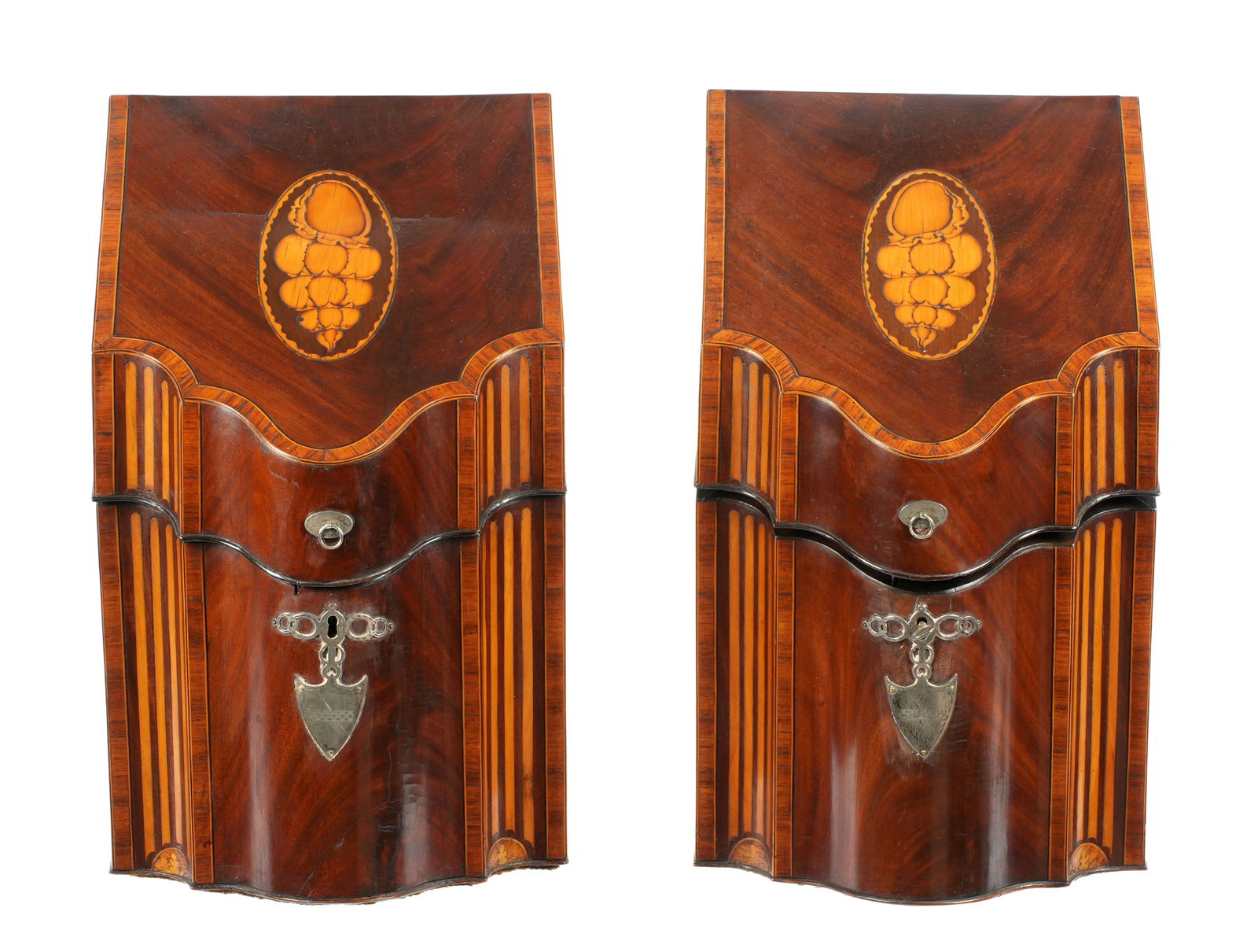 Pair Georgian Inlaid Mahogany Knife Boxes: Serpentine front, hinged lid inlaid with shell medallion, interior inlaid with star and herringbone band. banded mahogany base with conforming front, silver inlaid escutcheon with heraldic shield. Fit