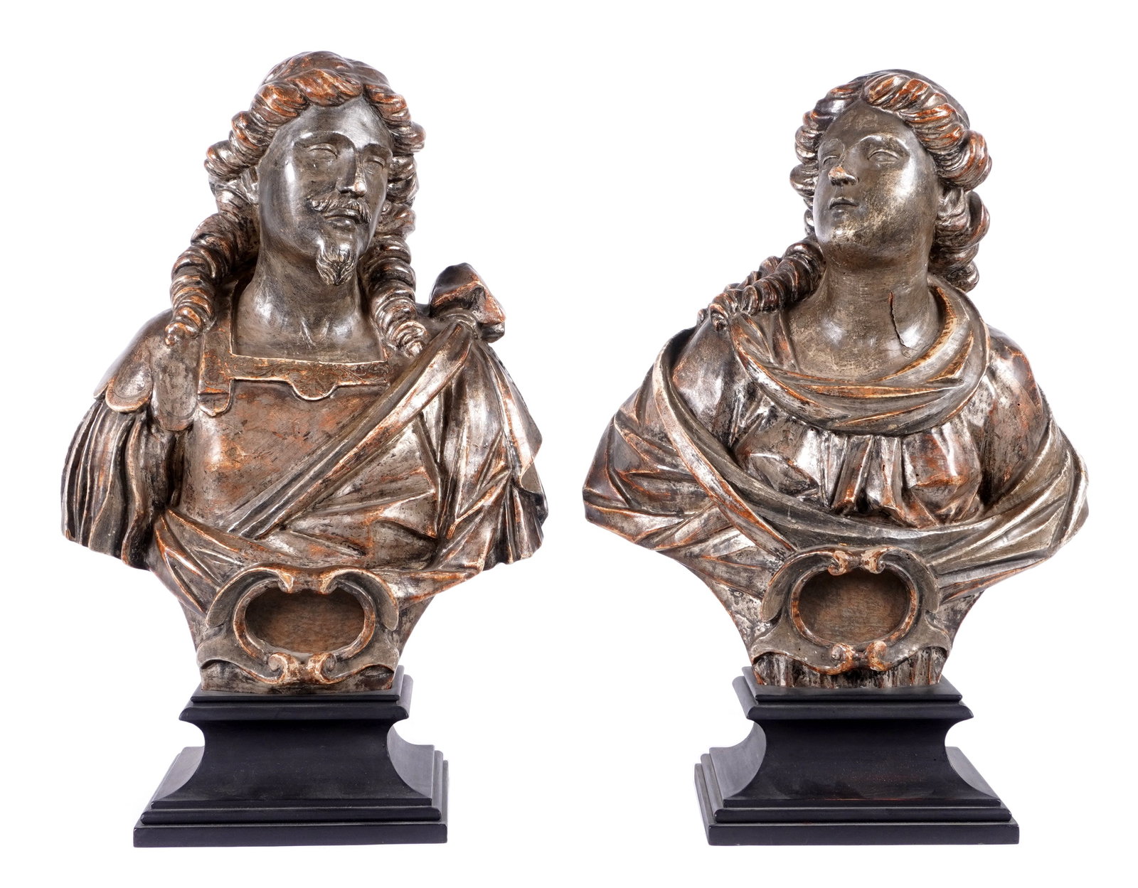 Pair Early Italian Carved Wood Reliquary Busts: Pair carved and paint decorated busts of a man and a woman to include 1) Bust of a man, most likely a saint, faux marble painted back marked with Roman numerals XXII, partial wax seals. Partial wax li