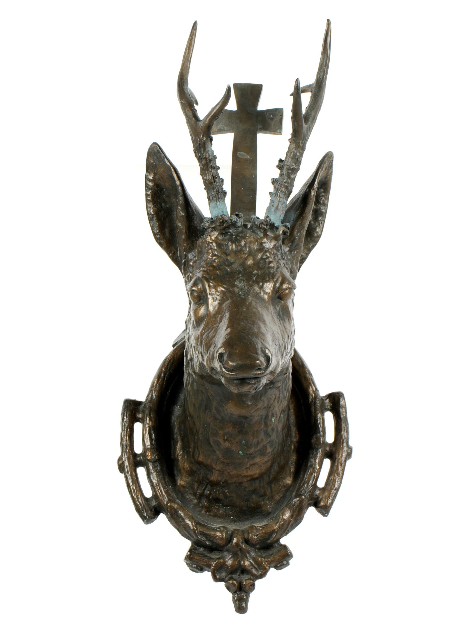 Continental Bronze St. Hubert Stag Head Wall Mount: Patinated bronze figural depiction of St. Hubert deer head mount with cross ascending behind ears. No visible markings, overall 21.5" h. x 9.25" x 10". Condition: Verdigris where horns attach.