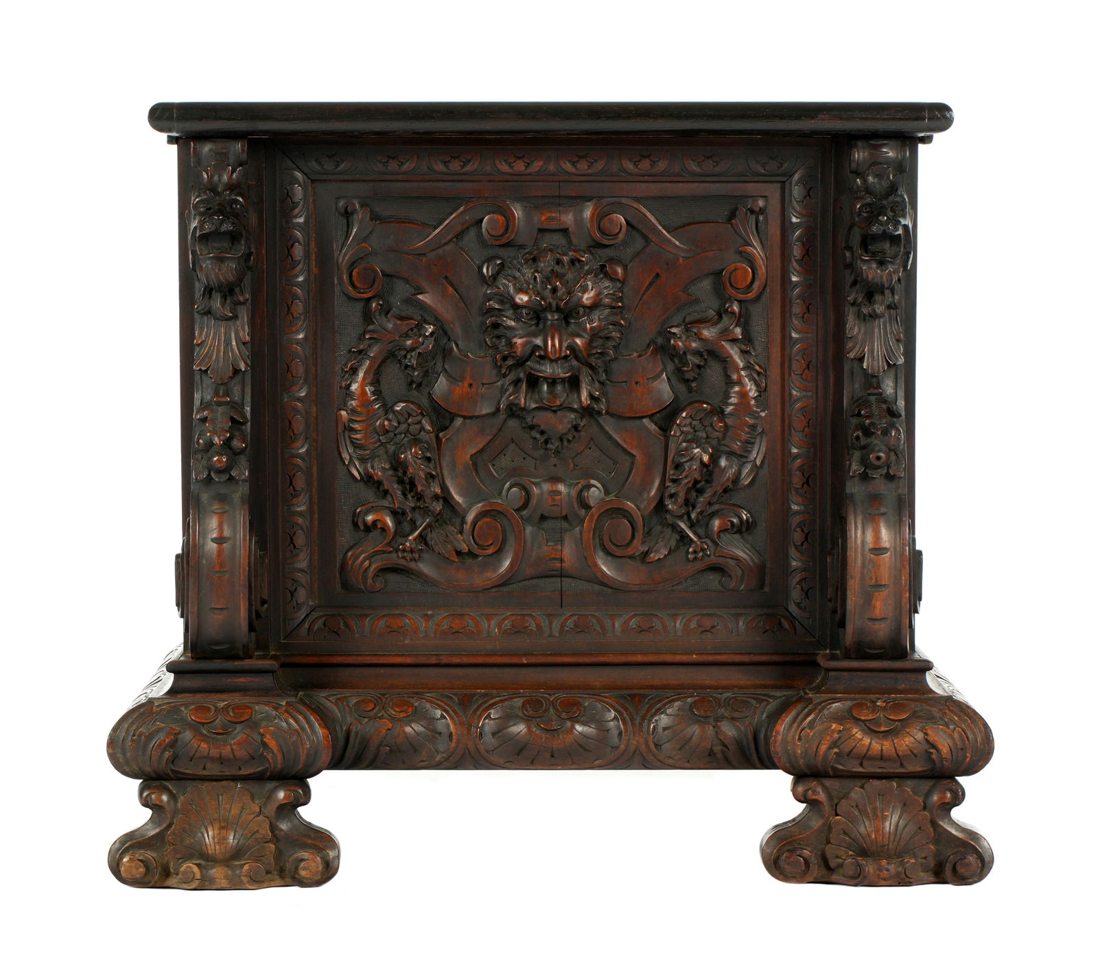 Tiffany Gothic Revival Carved Tall Case Clock Base: Ornately carved gothic revival style base for a Tiffany & Co. tall case grandfather clock.. Depicts stylized masks, figural dragons, foliate scroll and shell motifs. On large carved feet. Overall 23.2