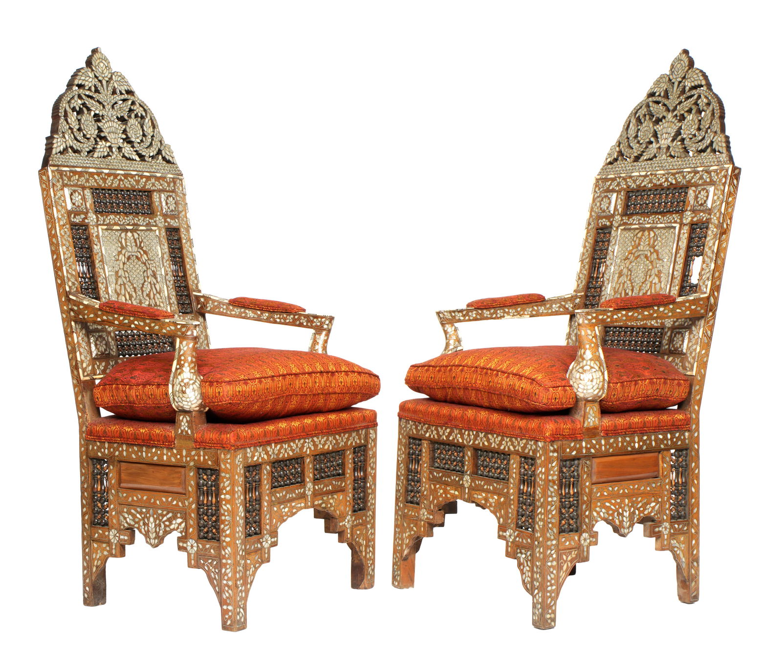 Pair Syrian Mother of Pearl Inlaid Arm Chairs: Ornately carved frame, profusely inlaid with mother of pearl and carved bone decoration. Urn, floral, and foliate scroll top crest, single back with mashrabiya accent panels, conforming inlaid apron..