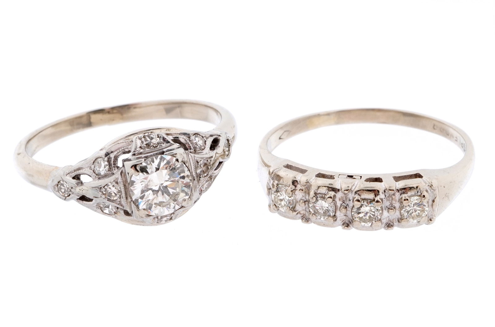 Two 14k White Gold and Diamond Wedding Rings: Two pieces total to include 1)14k white gold band, raised round center approx .7ct diamond, approx 10 small accent diamonds. Size 6.5. Approx 3 gram inclusive. 2) 14k white gold band, 4 prong set roun