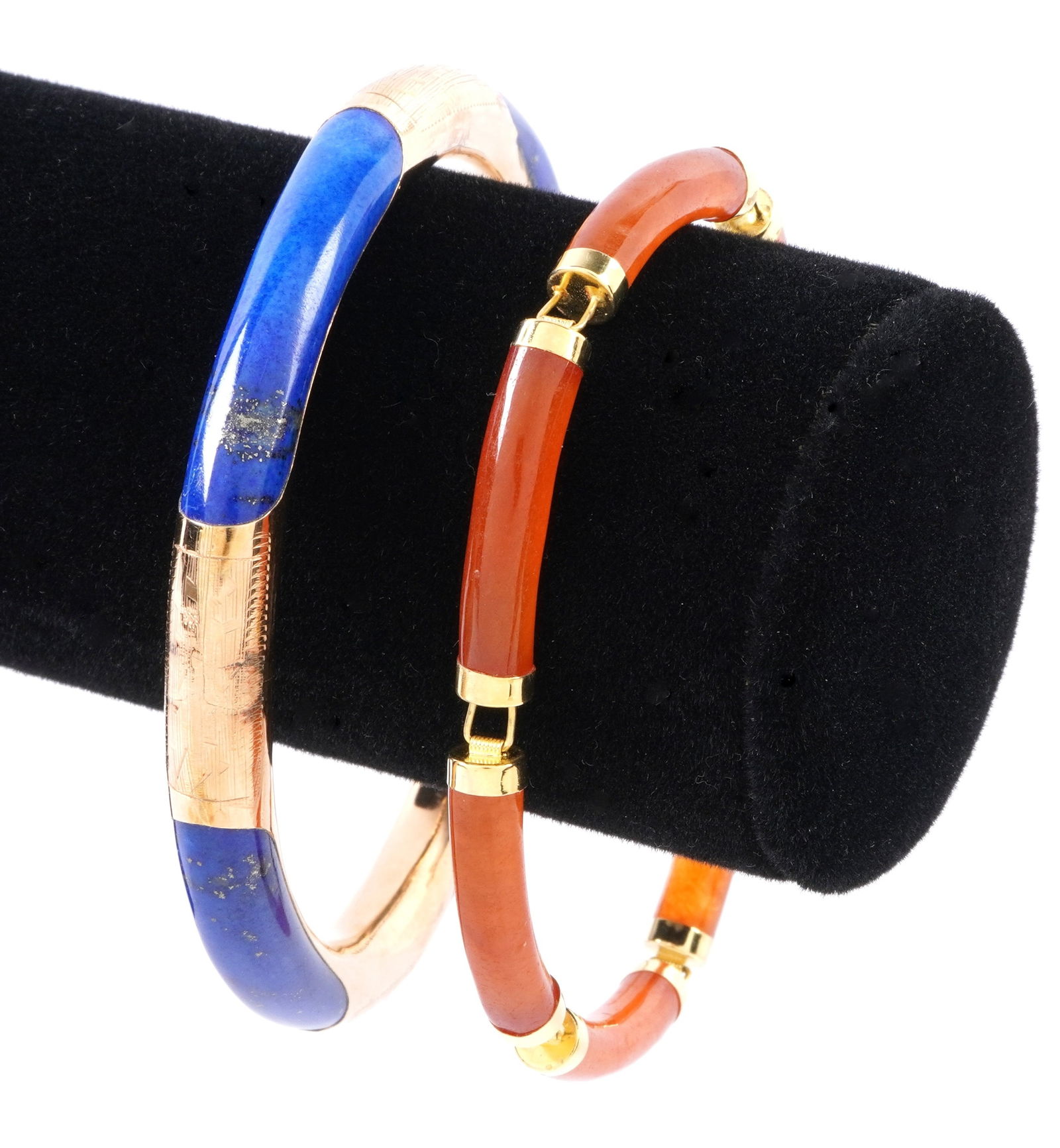 Two Chinese 14k Gold and Stone Bracelets: Two pieces total to include 1) 14k yellow gold with four inset lapis lazuli panels, one with crack. 3.75" exterior dia. 2) 14k yellow gold and six amber colored stone links. 3.5" exterior dia.