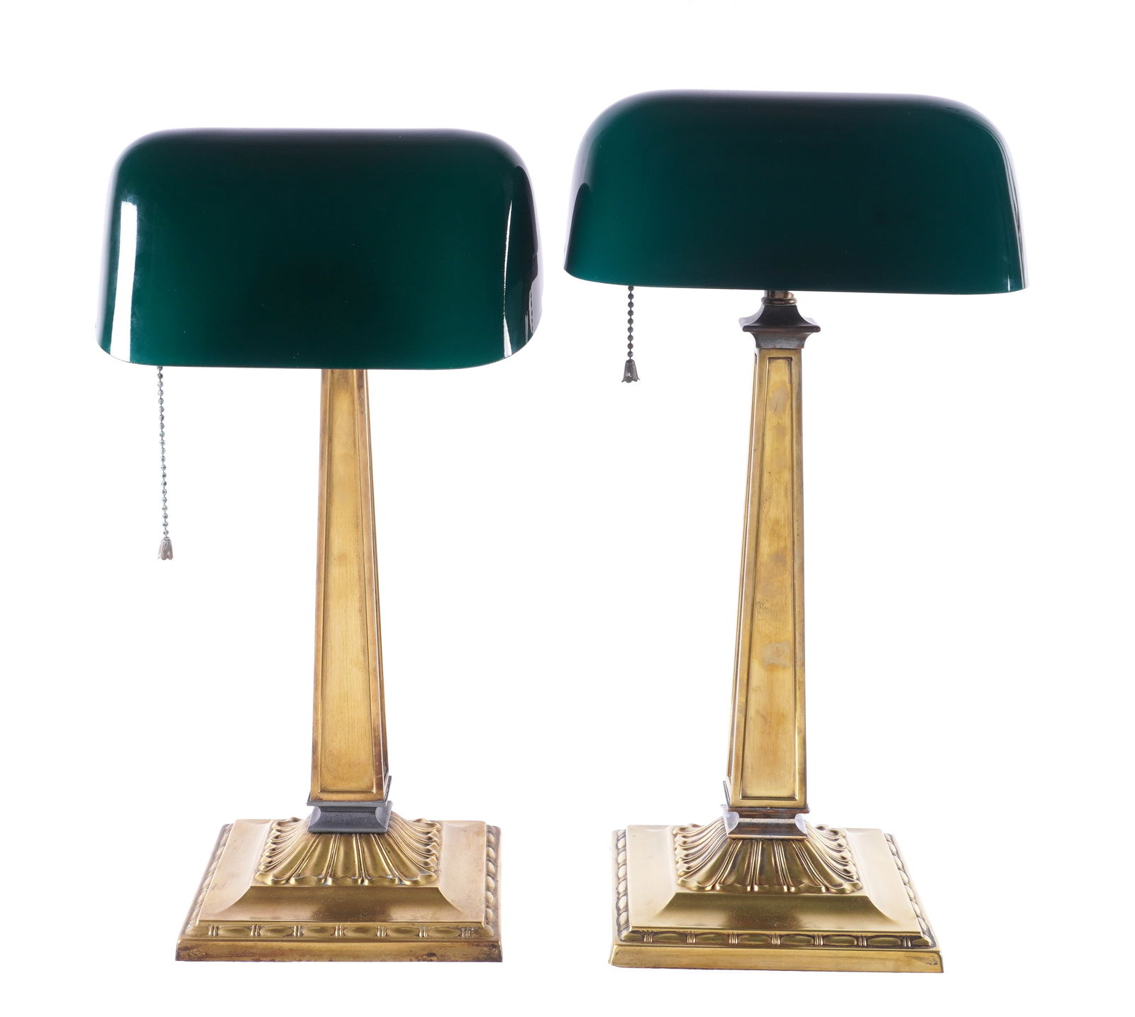 Pair McFadden Emeralite Desk Lamps 8734: Pair H. G. McFadden Emeralite bankers desk lamps, model 8734. Cased green glass shades, brass bases, both bases marked with Emeralite plaques. Overall with shade 17.5" h. x 8.75" x 8.75". Condition: U