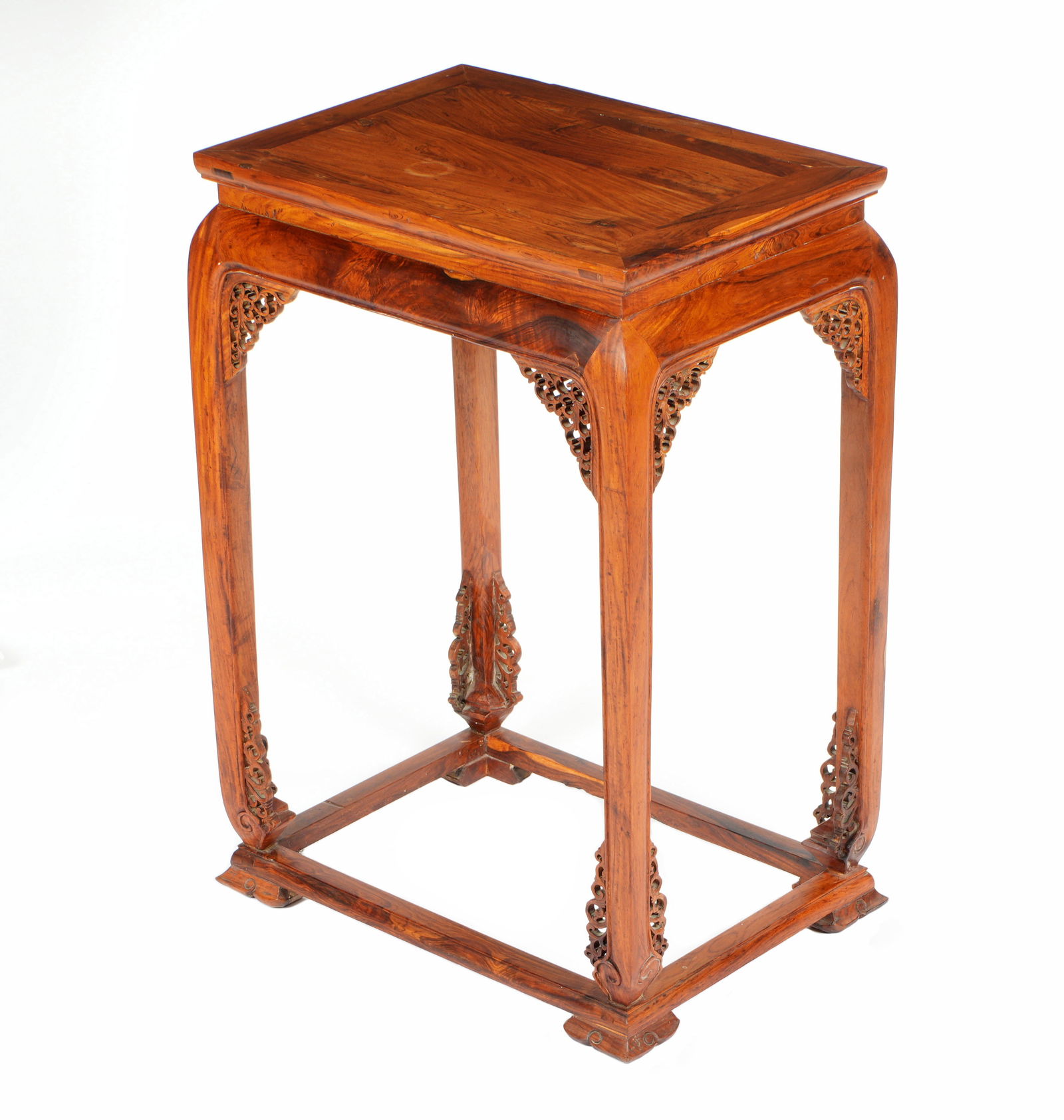 Chinese Huanghuali Stand Side Table: 20th Century Chinese Huanghuali or similar wood. Rectangular top over bowed skirt. Reticulated pierced carved accent panels at joints. Straight legs and stretchers, on four carved feet. Overall 31.75"