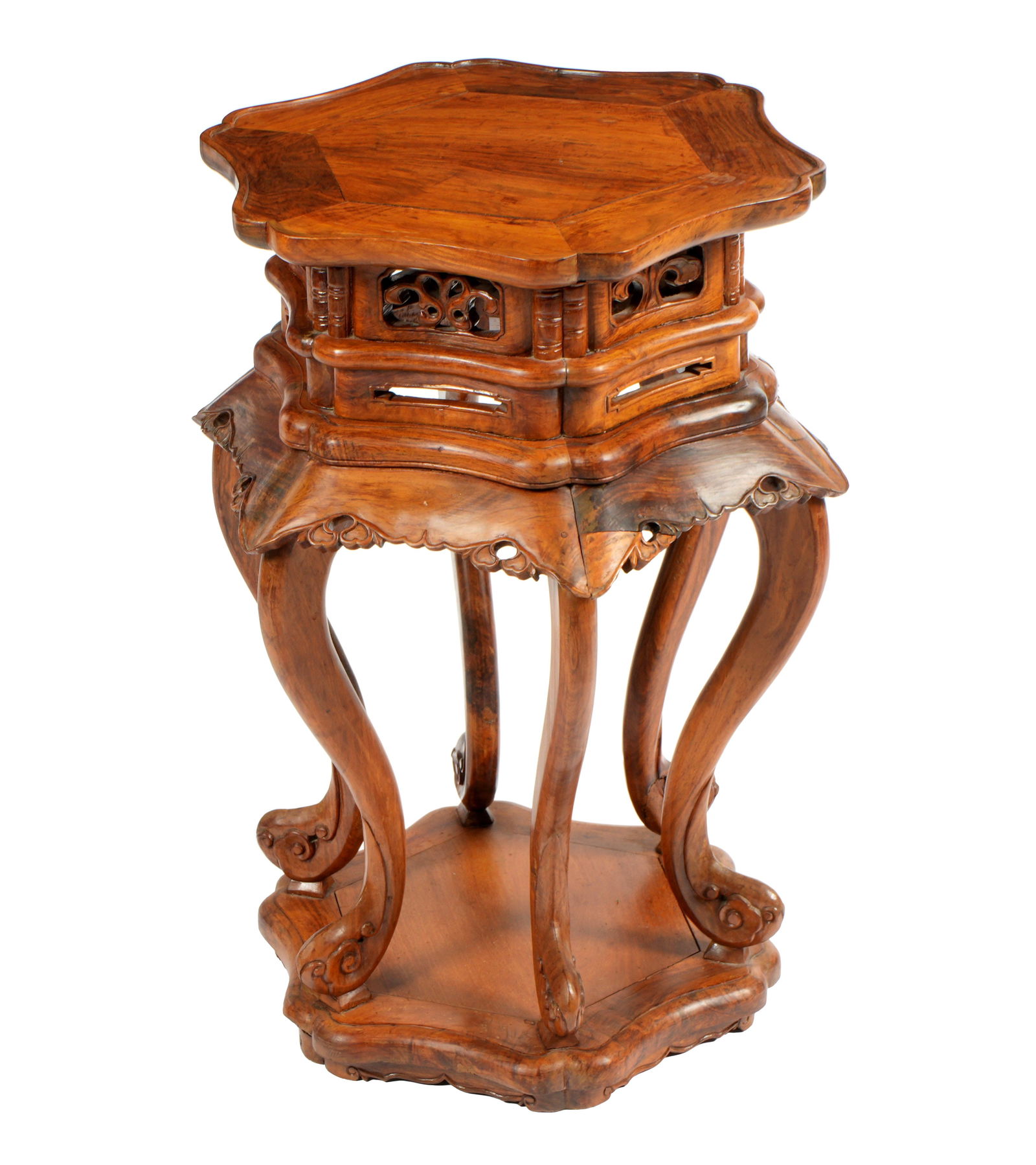 Chinese Huanghuali Pagoda Form Stand: 20th Century Chinese Huanghuali or similar wood stand or side table. Serpentine hexagonal top over conforming pagoda form support with reticulated pierced carved panels. Six shaped legs ending in carv