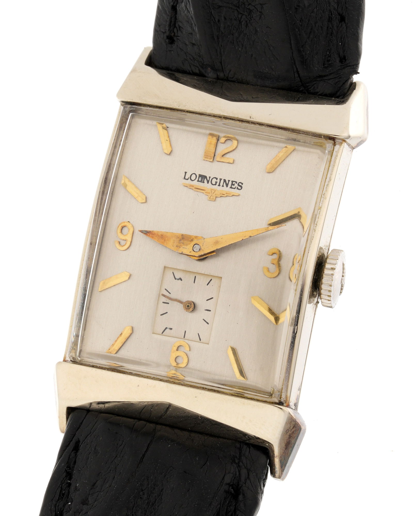 Longines 14k Gold Tank Wrist Watch: 21mm x 35mm 14k white gold case, manual wind movement, silvered dial with subsidiary seconds dial. Crocodile leather strap, 8.25" long. Condition: Minor signs wear. Currently running however not guara